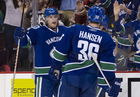 VANCOUVER, CANADA - MARCH 31: Christian Ehrhoff #5 of the Vancouver Canucks celebrates with teammate Jannik Hansen #36 after scoring against of Los Angeles Kings during the second period in NHL action on March 31, 2011 at Rogers Arena in Vancouver, BC, Ca