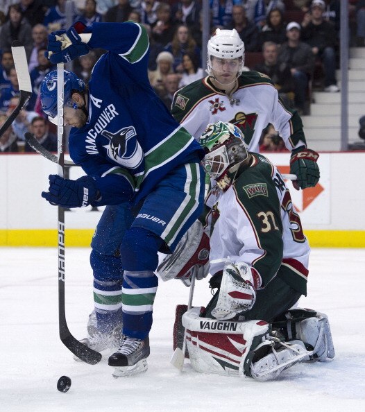 VANCOUVER, CANADA - APRIL 7: Ryan Kesler #17 of the Vancouver Canucks tries to redirect the puck past goalie Niklas Backstrom #32 of the Minnesota Wild during the second period in NHL action on April 07, 2011 at Rogers Arena in Vancouver, BC, Canada.  (Ph