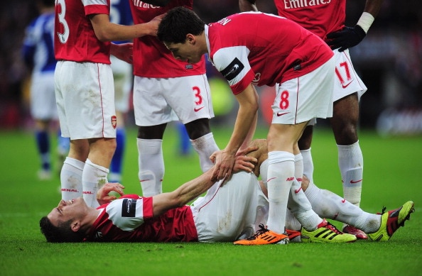 LONDON, ENGLAND - FEBRUARY 27: Robin van Persie of Arsenal lies on the ground as he is spoken to by Samir Nasri during the Carling Cup Final between Arsenal and Birmingham City at Wembley Stadium on February 27, 2011 in London, England.  (Photo by Shaun B