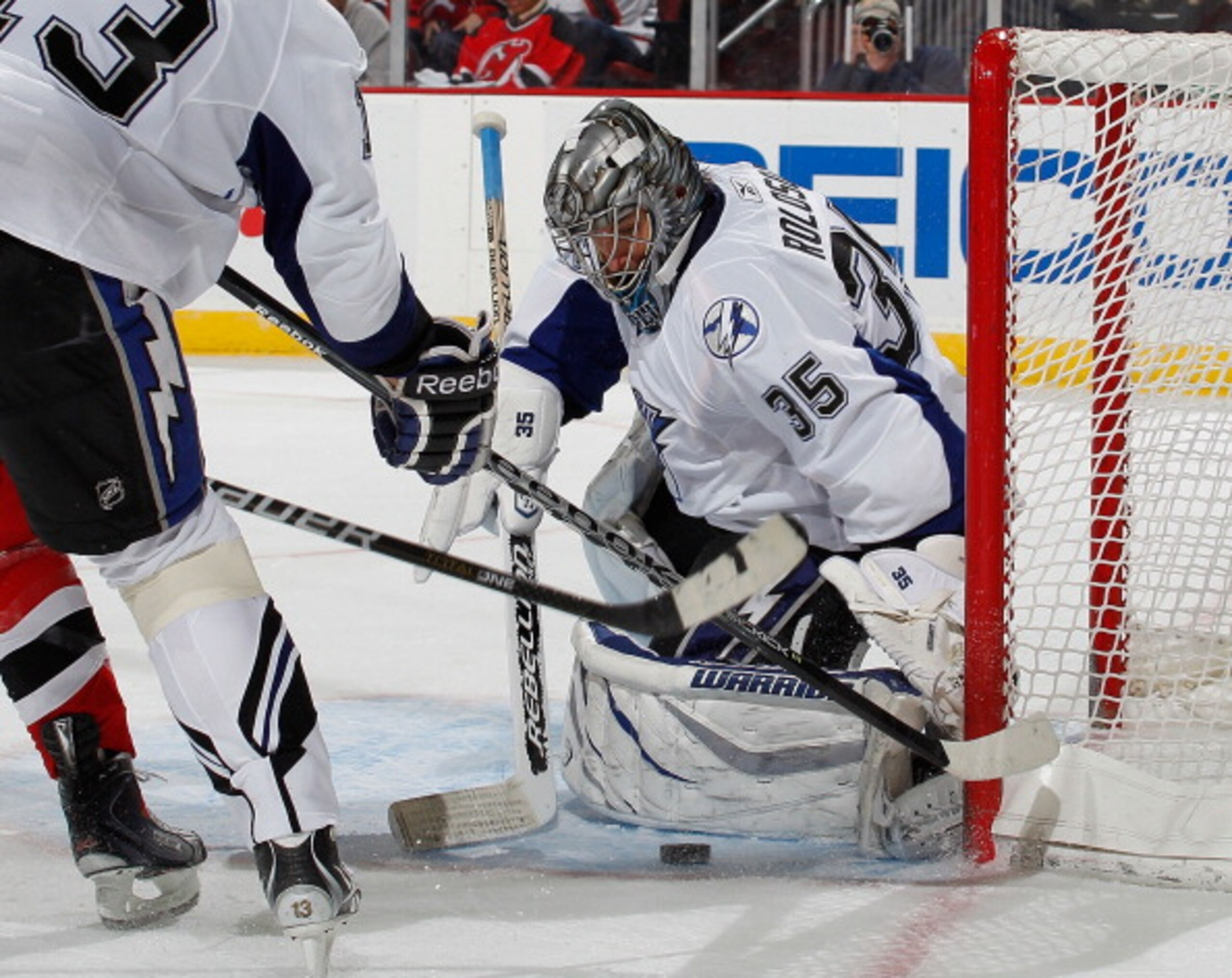 NEWARK, NJ - MARCH 02:  Goalie Dwayne Roloson #35 of the Tampa Bay Lightning makes a save against the New Jersey Devils during the second period of an NHL hockey game at the Prudential Center on March 2, 2011 in Newark, New Jersey. Devils won 2-1. (Photo