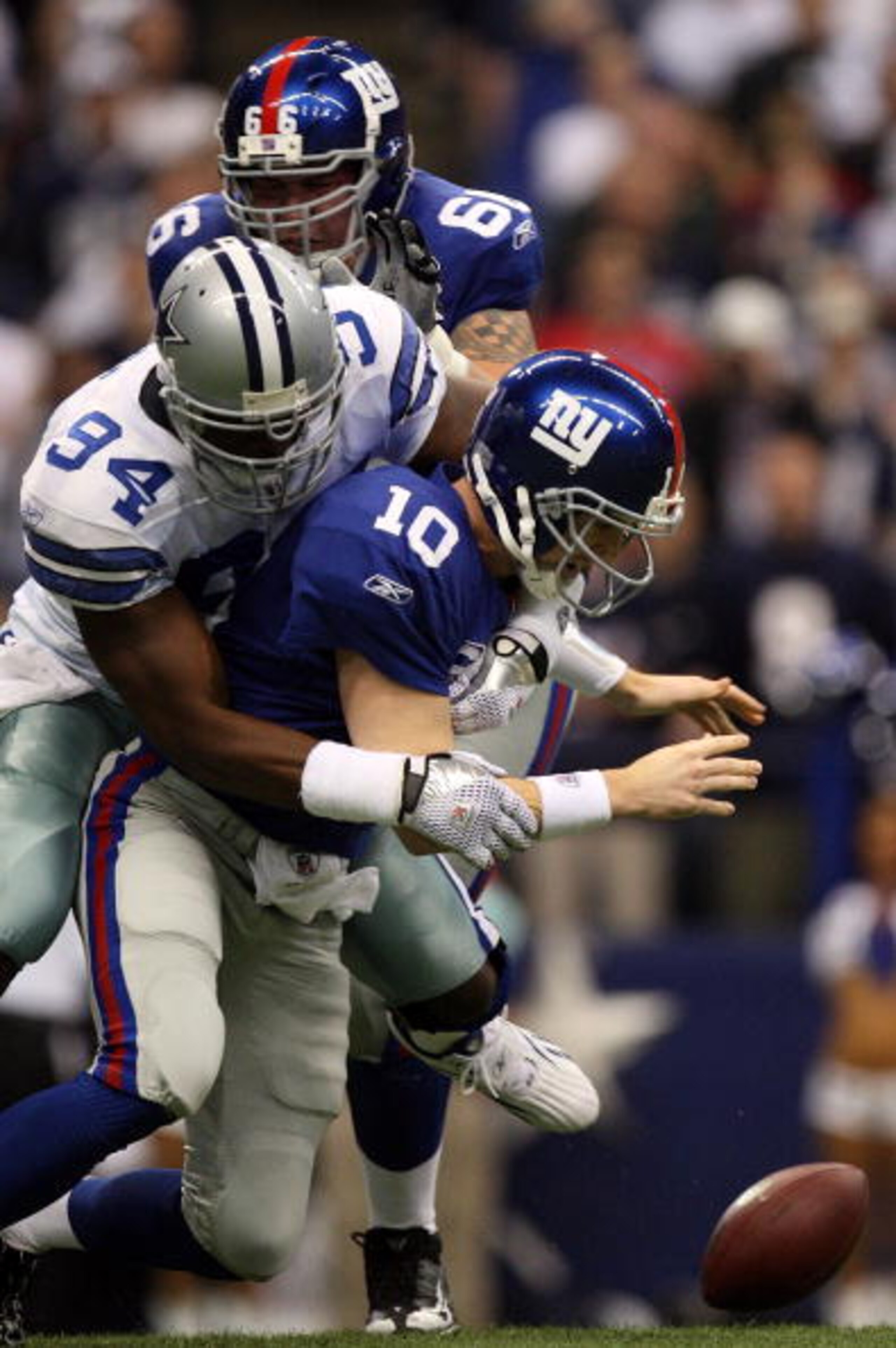 IRVING, TX - DECEMBER 14: Quarterback Eli Manning #10 of the New York Giants fumbles the ball while sacked by DeMarcus Ware #94 of the Dallas Cowboys in the first quarter at Texas Stadium on December 14, 2008 in Irving, Texas. (Photo by Ronald Martinez/ IRVING, TX - DECEMBER 14: Quarterback Eli Manning #10 of the New York Giants fumbles the ball while sacked by DeMarcus Ware #94 of the Dallas Cowboys in the first quarter at Texas Stadium on December 14, 2008 in Irving, Texas. (Photo by Ronald Martinez/