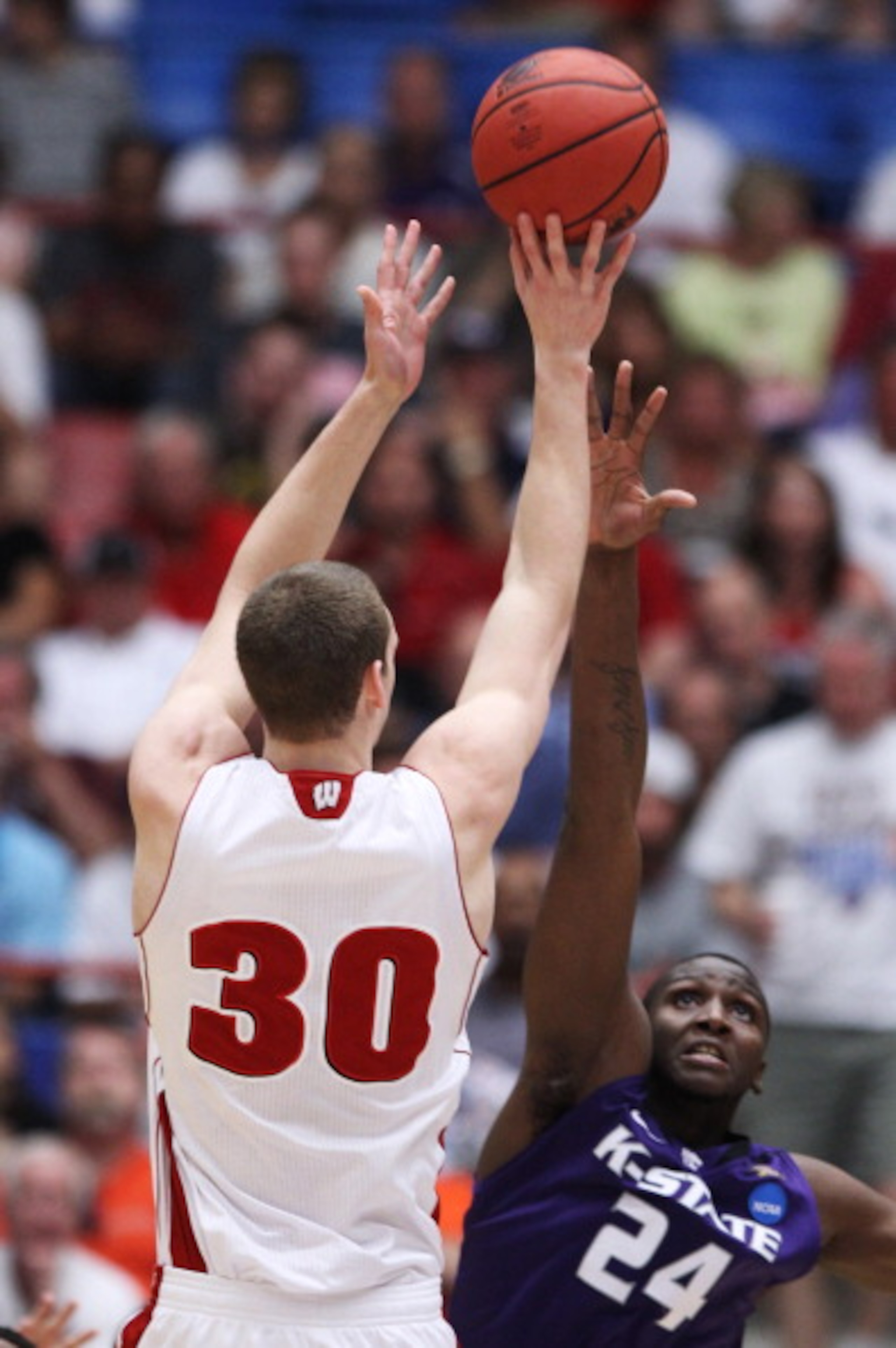 TUCSON, AZ - MARCH 19:  Jon Leuer #30 of the Wisconsin Badgers shoots over Curtis Kelly #24 of the Kansas State Wildcats in the first half during the third round of the 2011 NCAA men's basketball tournament at McKale Center on March 19, 2011 in Tucson, Ar