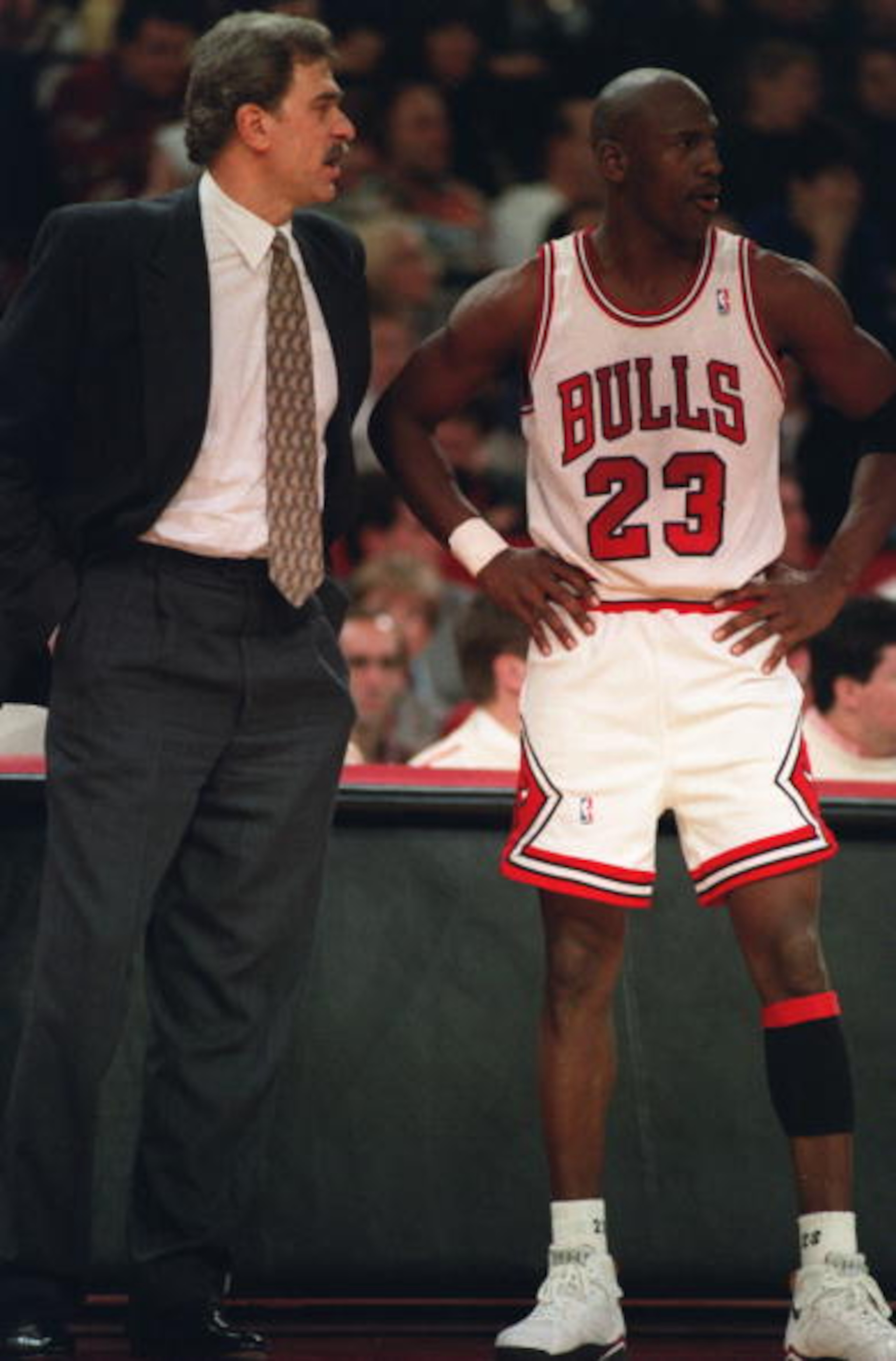CHICAGO BULLS HEAD COACH PHIL JACKSON AND GUARD MICHAEL JORDAN DISCUSS THEIR GAME AGAINST THE CHARLOTTE HORNETS AT CHICAGO STADIUM IN CHICAGO, ILLINOIS.