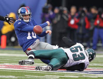 EAST RUTHERFORD, NJ - DECEMBER 19: Eli Manning #10 of the New York Giants is sacked by Moise Fokou #53 of the Philadelphia Eagles during their game on December 19, 2010 at The New Meadowlands Stadium in East Rutherford, New Jersey. (Photo by Al Bello/Ge EAST RUTHERFORD, NJ - DECEMBER 19: Eli Manning #10 of the New York Giants is sacked by Moise Fokou #53 of the Philadelphia Eagles during their game on December 19, 2010 at The New Meadowlands Stadium in East Rutherford, New Jersey. (Photo by Al Bello/Ge