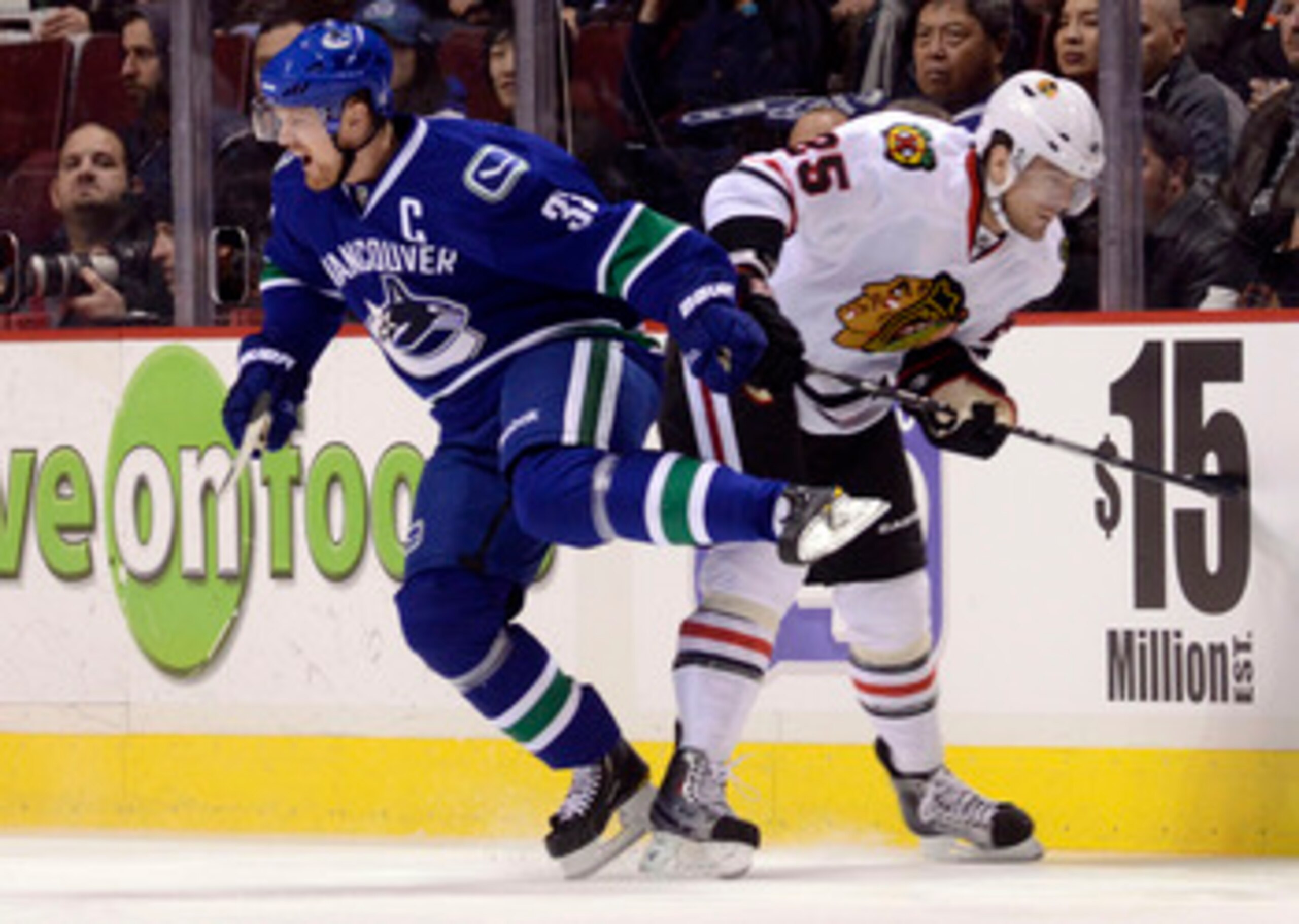 VANCOUVER, CANADA - FEBRUARY 4: Henrik Sedin #33 of the Vancouver Canucks reacts after colliding with Viktor Stalberg #25 of the Chicago Blackhawks during the first period in NHL action on February 04, 2011 at Rogers Arena in Vancouver, British Columbia,
