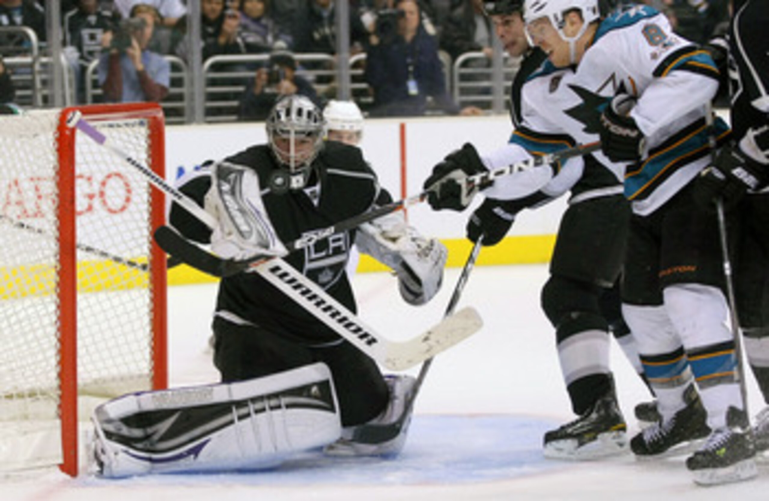 LOS ANGELES, CA - MARCH 24:  Goaltender Jonathan Quick #32 of the Los Angeles Kings makes a save as Joe Pavelski #8 of the San Jose Sharks looks for the rebound during the NHL game at Staples Center on March 24, 2011 in Los Angeles, California. The Kings