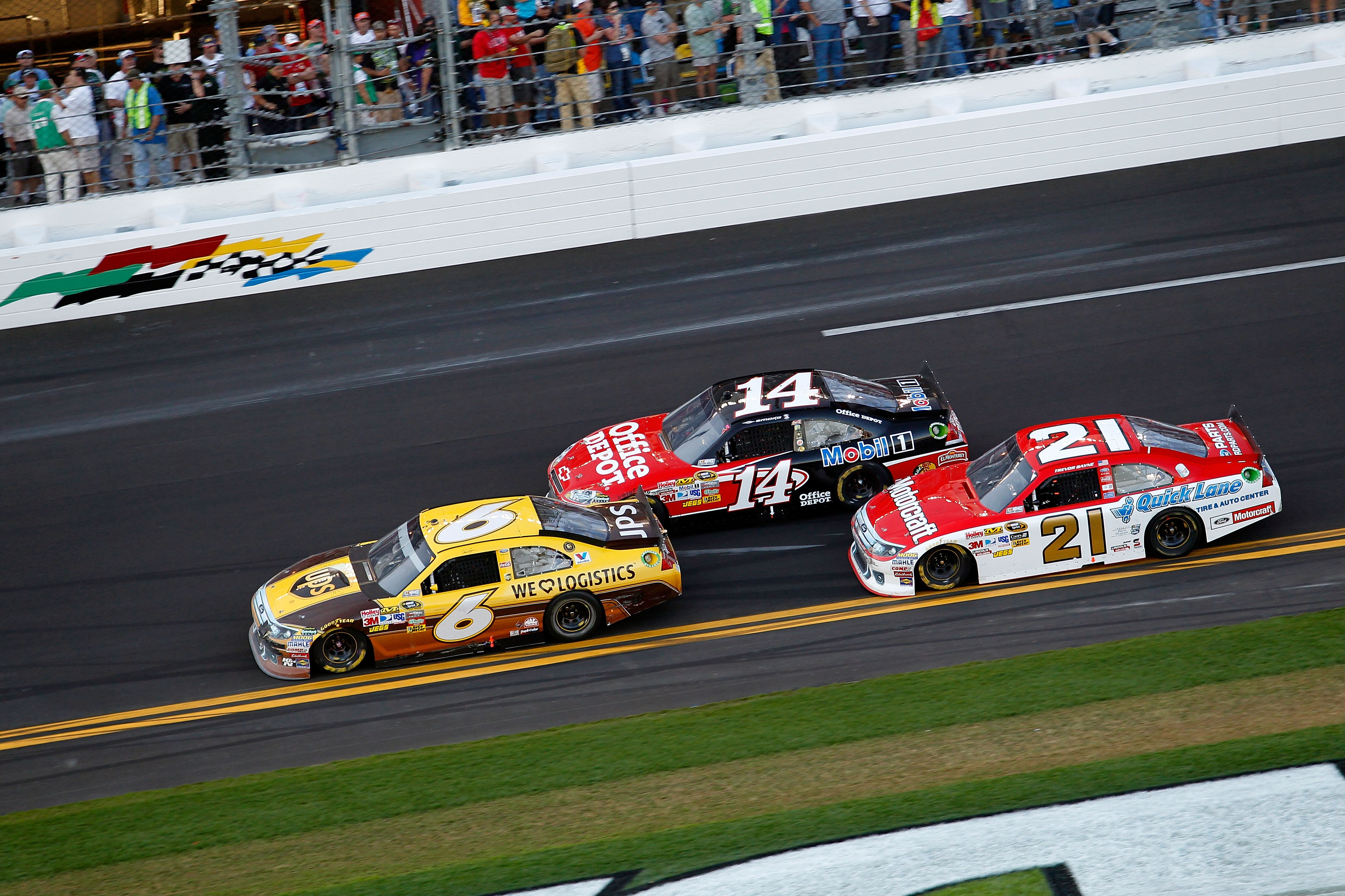 DAYTONA BEACH, FL - FEBRUARY 20:  David Ragan, driver of the #6 UPS Ford, Tony Stewart, driver of the #14 Mobil 1/Office Depot Chevrolet, and Trevor Bayne, driver of the #21 Motorcraft/Quick Lane Ford, race during the NASCAR Sprint Cup Series Daytona 500