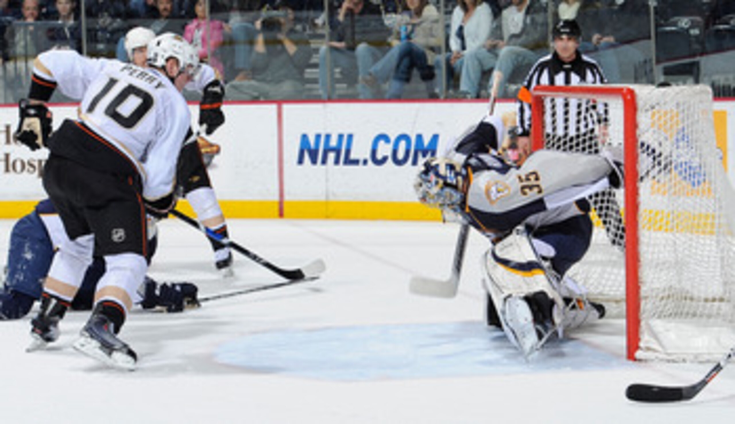 NASHVILLE, TN - MARCH 24: Corey Perry #10 of the Anaheim Ducks watches a puck shot by teammate Teemu Selanne #8 get past Pekka Rinne #35 of the Nashville Predators for a goal on March 24, 2011 at the Bridgestone Arena in Nashville, Tennessee.  (Photo by F