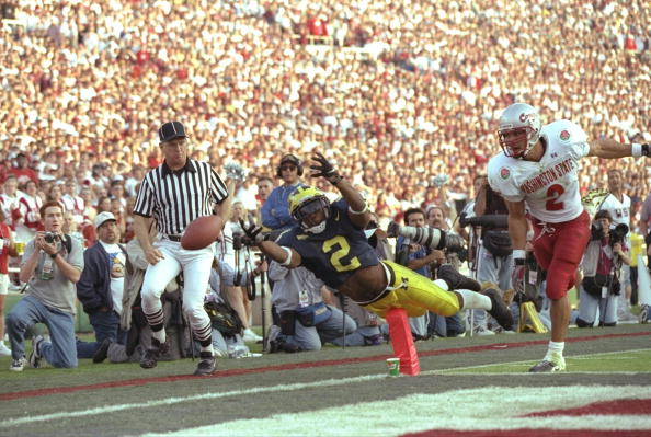Charles Woodson #2 of Michigan makes a diving attempt to catcha a pass on Ray Jackson of Washington State during the Wolverines 21-16 win over Washington State in the 1998 Rose Bowl at the Rose Bowl in Pasadena, California.