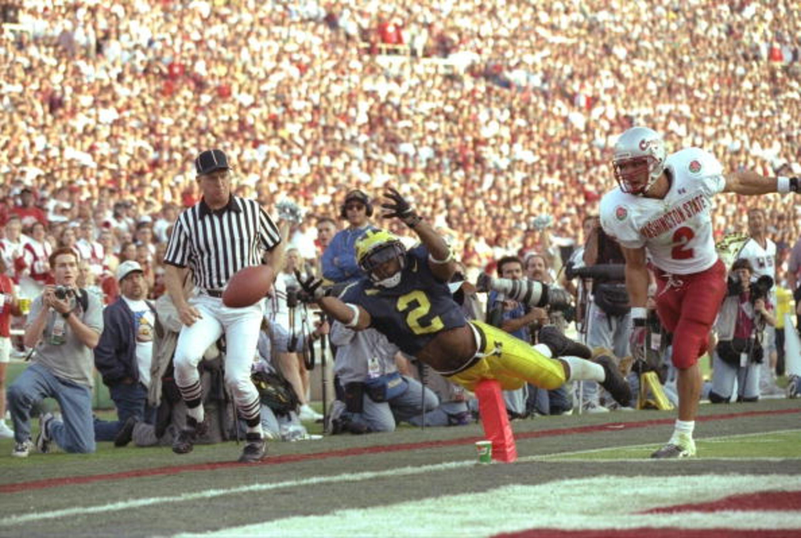 Charles Woodson #2 of Michigan makes a diving attempt to catcha a pass on Ray Jackson of Washington State during the Wolverines 21-16 win over Washington State in the 1998 Rose Bowl at the Rose Bowl in Pasadena, California.