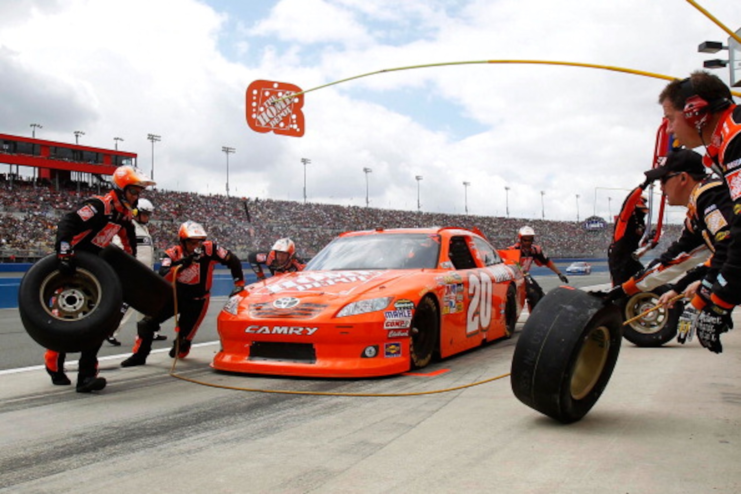 FONTANA, CA - MARCH 27:  Joey Logano, driver of the #20 The Home Depot Toyota, makes a pit stop during the NASCAR Sprint Cup Series Auto Club 400 at Auto Club Speedway on March 27, 2011 in Fontana, California.  (Photo by Todd Warshaw/Getty Images for NASC