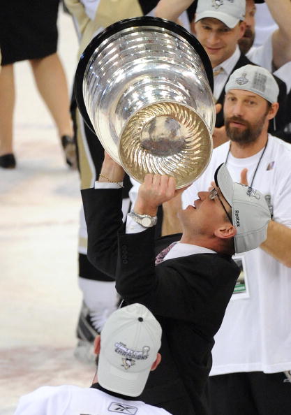 DETROIT - JUNE 12:  Head Coach Dan Bylsma of the Pittsburgh Penguins looks to kiss the Stanley Cup after Game Seven of the 2009 NHL Stanley Cup Finals against the Detroit Red Wings at Joe Louis Arena on June 12, 2009 in Detroit, Michigan. The Penguins def