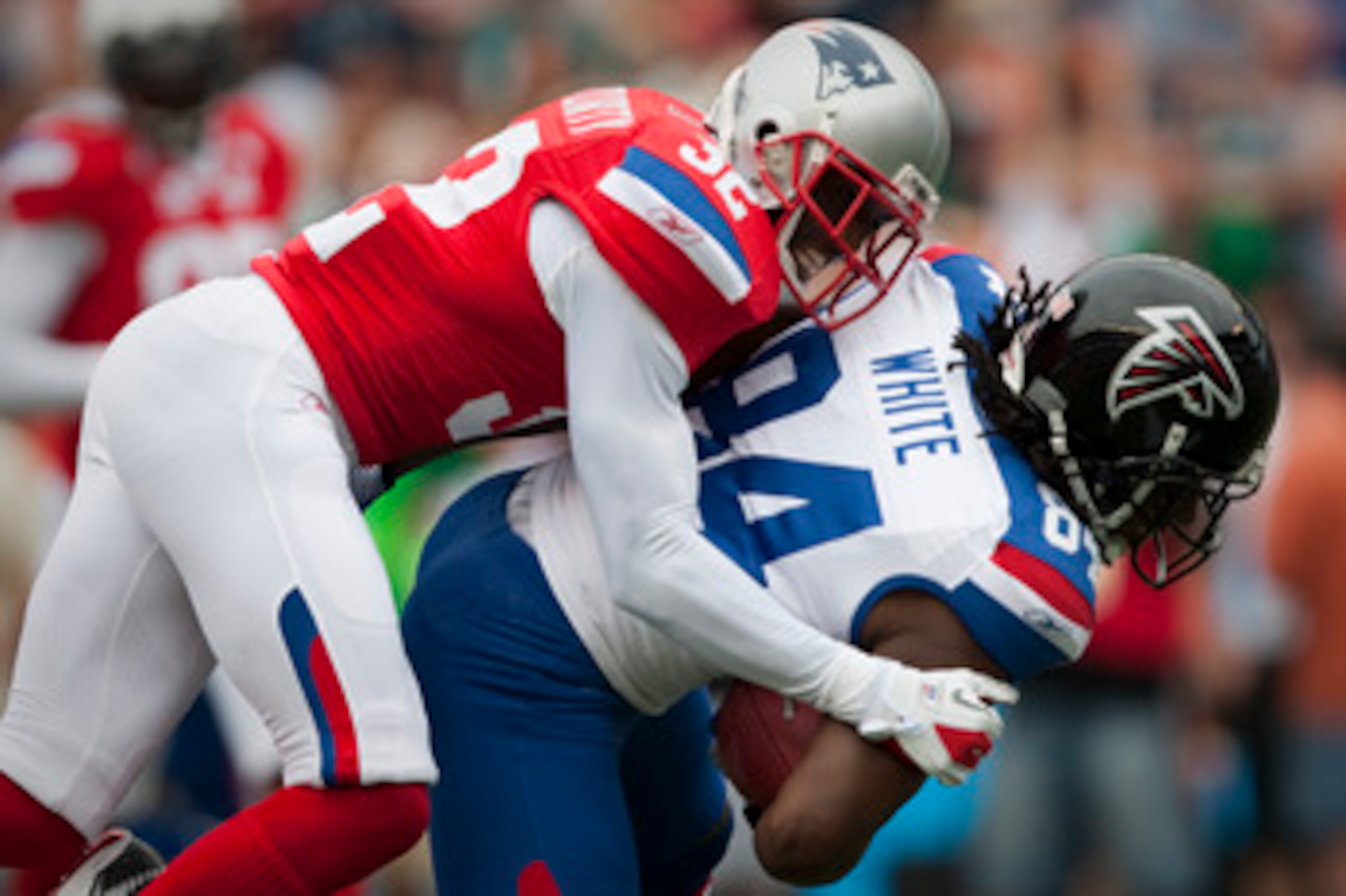 HONOLULU - JANUARY 30:  Devin McCourty, #32 of the New England Patriots, tackles Roddy White, #84 of the Atlanta Falcons, during the 2011 NFL Pro Bowl at Aloha Stadium on January 30, 2011 in Honolulu, Hawaii.  (Photo by Kent Nishimura/Getty Images)