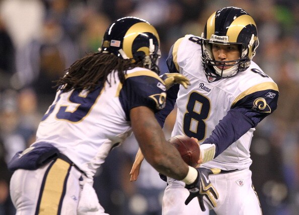 SEATTLE, WA - JANUARY 02:  Quarterback Sam Bradford #8 of the St. Louis Rams hands the ball off to running back Steven Jackson #39 during their game against the Seattle Seahawks at Qwest Field on January 2, 2011 in Seattle, Washington.  (Photo by Otto Gre