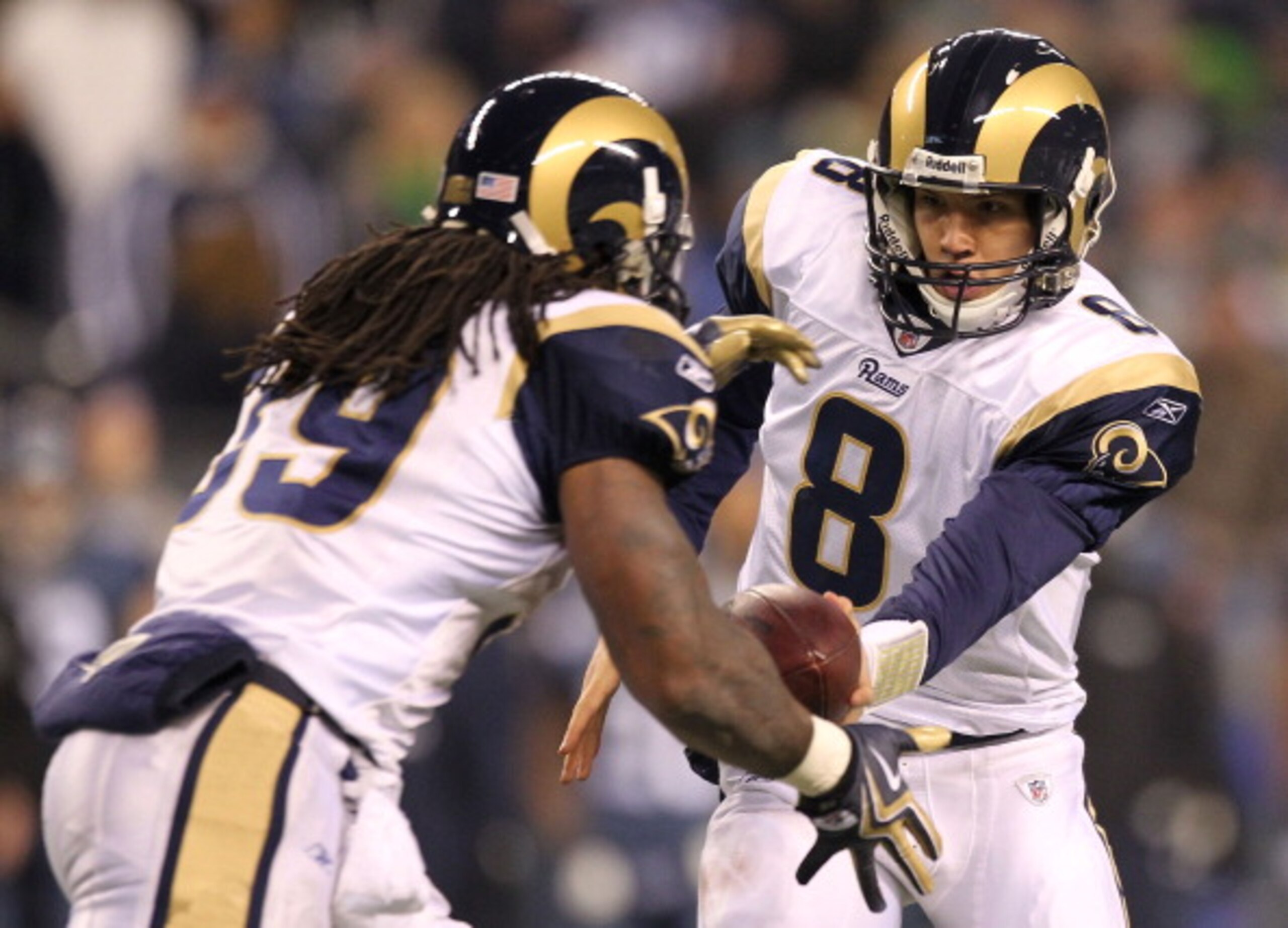 SEATTLE, WA - JANUARY 02:  Quarterback Sam Bradford #8 of the St. Louis Rams hands the ball off to running back Steven Jackson #39 during their game against the Seattle Seahawks at Qwest Field on January 2, 2011 in Seattle, Washington.  (Photo by Otto Gre