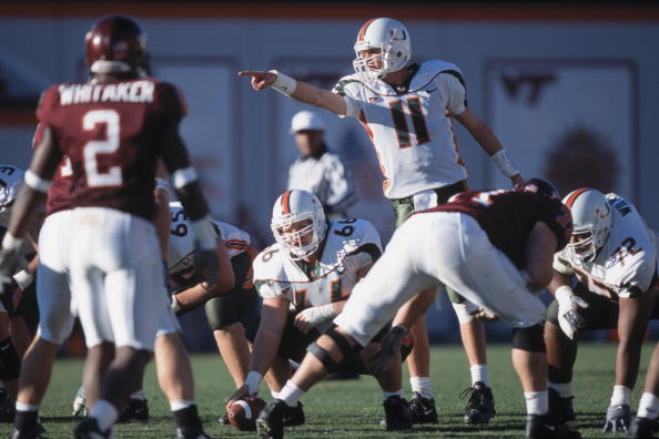 1 Dec 2001:  Quarterback Ken Dorsey #11 of the Miami Hurricanes calls a play as his teammate Brett Romberg #66 prepares to snap the ball during the NCAA game against the Virginia Tech Hokies at Lane Stadium in Blacksburg, Virginia.  Miami defeated Virgini