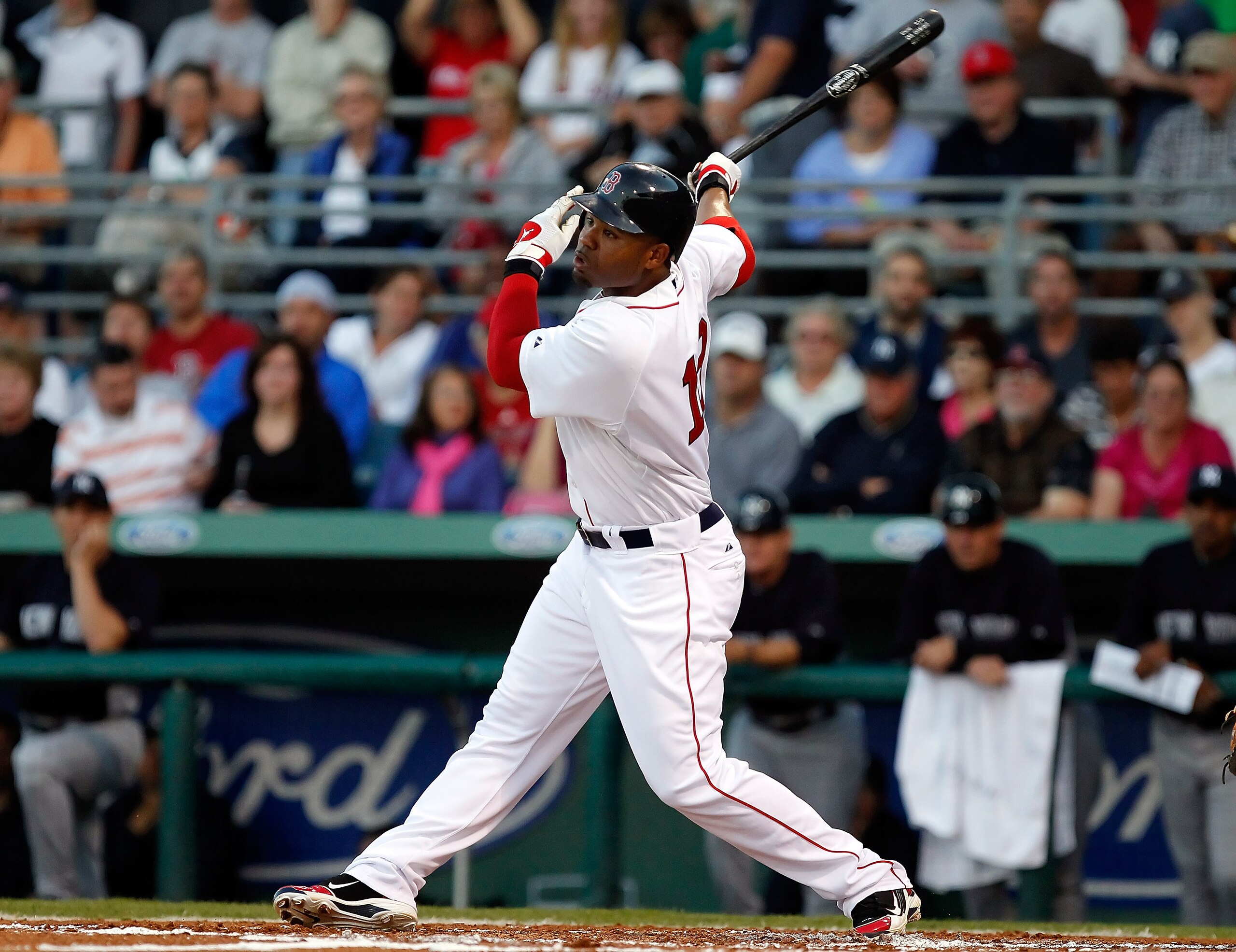 FORT MYERS, FL - MARCH 14:  Outfielder Carl Crawford #13 of the Boston Red Sox fouls off a pitch against the New York Yankees during a Grapefruit League Spring Training Game at City of Palms Park on March 14, 2011 in Fort Myers, Florida.  (Photo by J. Mer