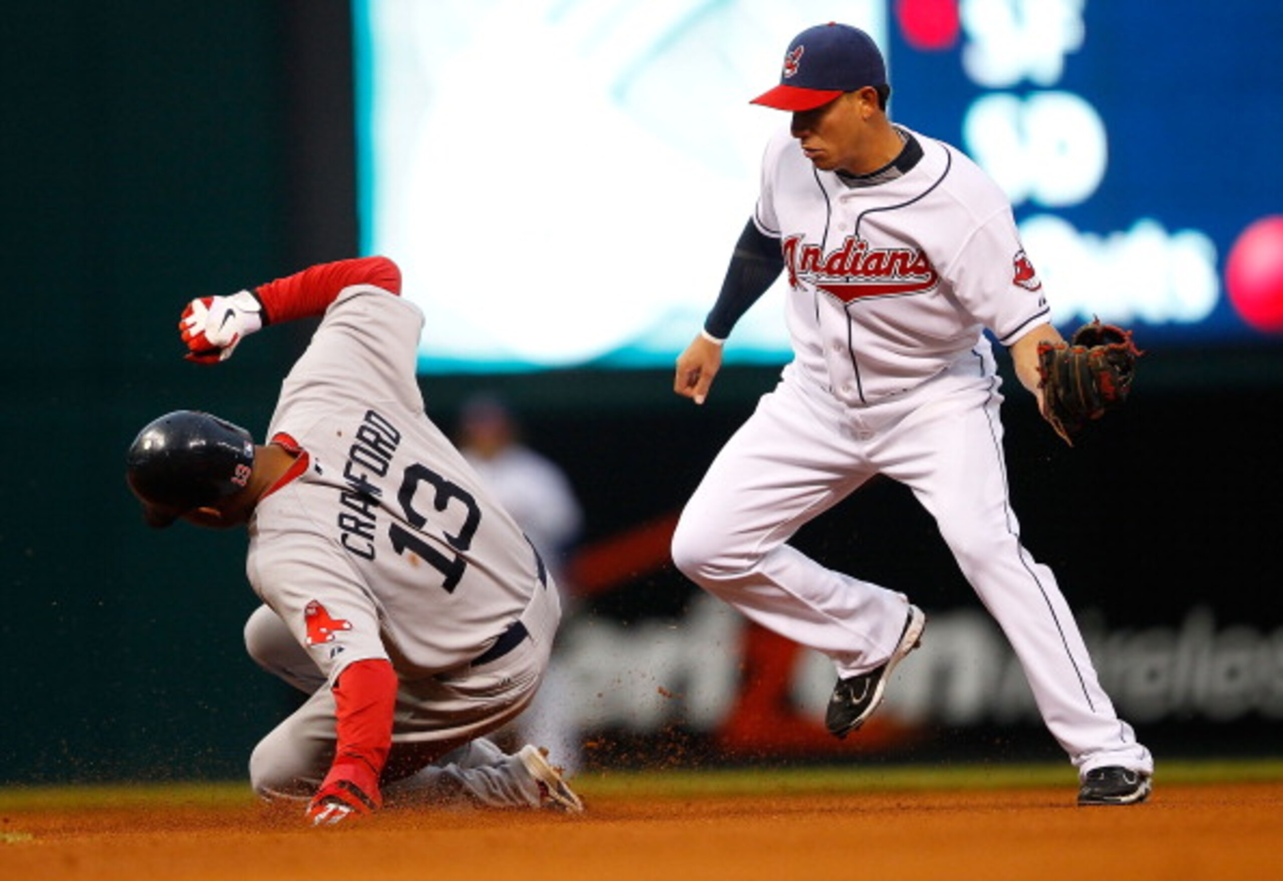 CLEVELAND - APRIL 06:  Carl Crawford #13 of the Boston Red Sox steals second base in front of Orlando Cabrera #20 of the Cleveland Indians during the game on April 6, 2011 at Progressive Field in Cleveland, Ohio.  (Photo by Jared Wickerham/Getty Images)