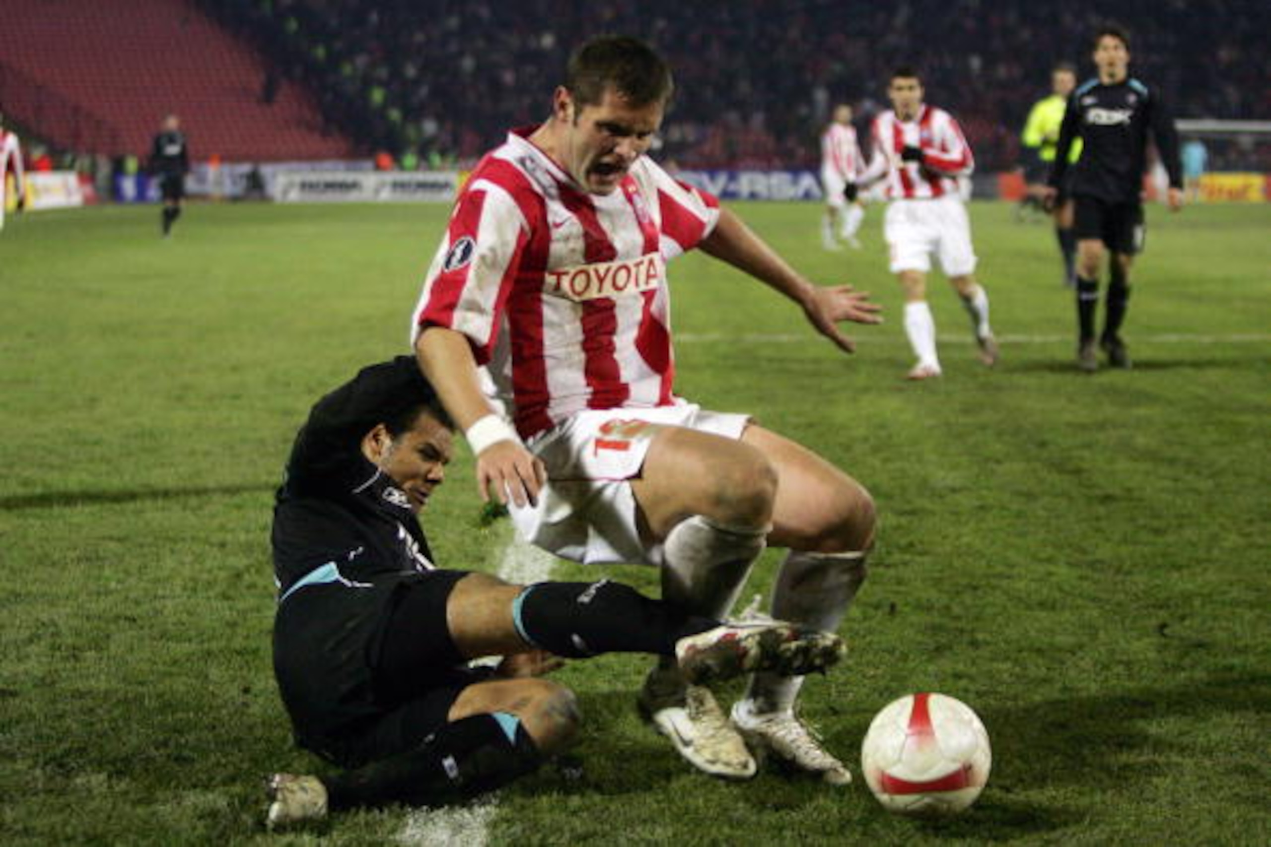 BELGRADE, SERBIA AND MONTENEGRO - DECEMBER 06:  Daniel Braaten (left) of Bolton challenges Dorde Tutoric during the Crvena Zvezda v Bolton Wanderers UEFA Cup Group F match between Crvena Zvezda and Bolton Wanderers at the FK Crvena Zvezda Stadium  on Dece