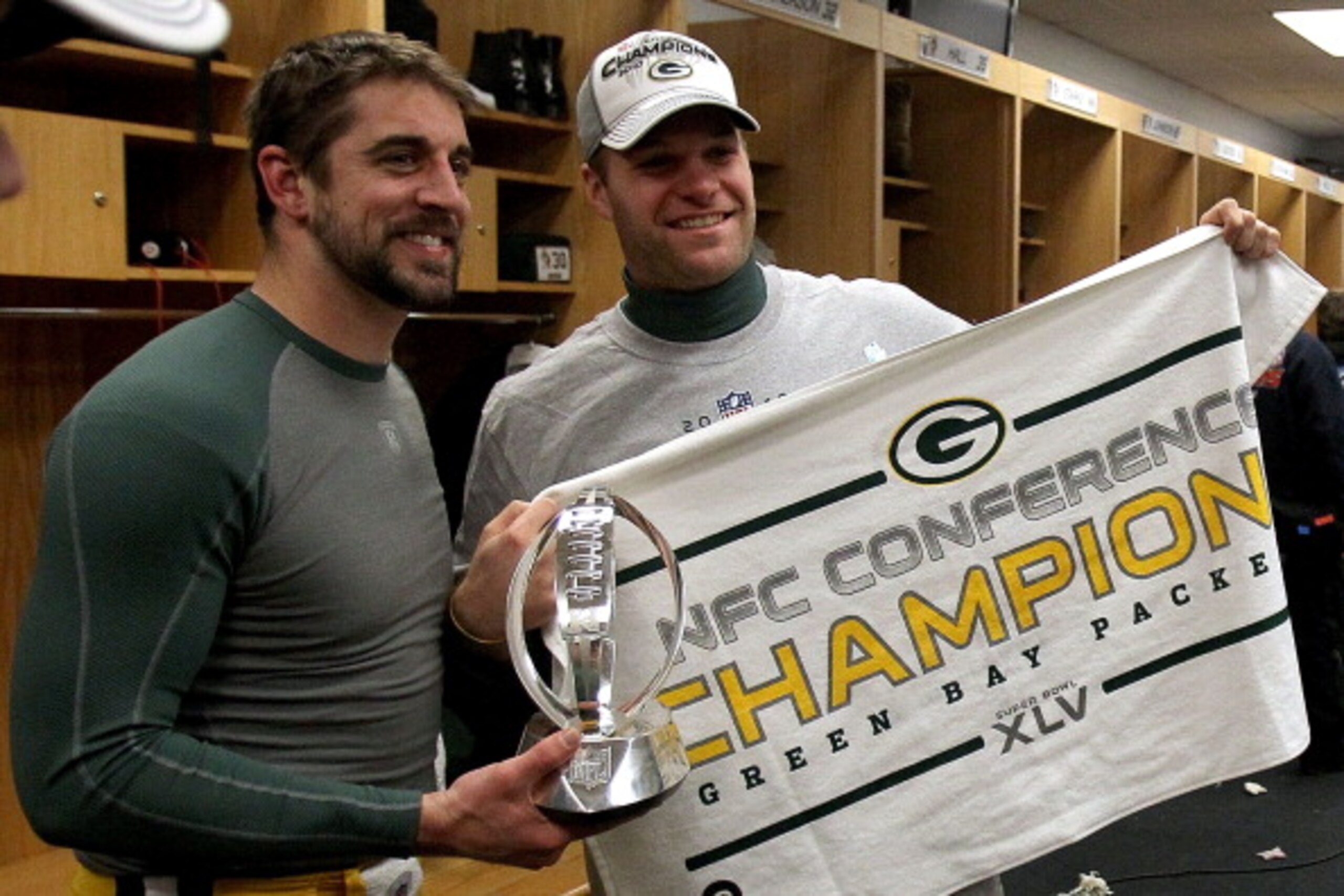 CHICAGO, IL - JANUARY 23:  (L-R) Quarterback Aaron Rodgers #12 and Matt Flynn #10 of the Green Bay Packers celebrate the Packers 21-14 victory against the Chicago Bears with the George Halas Trophy after the NFC Championship Game at Soldier Field on Janua