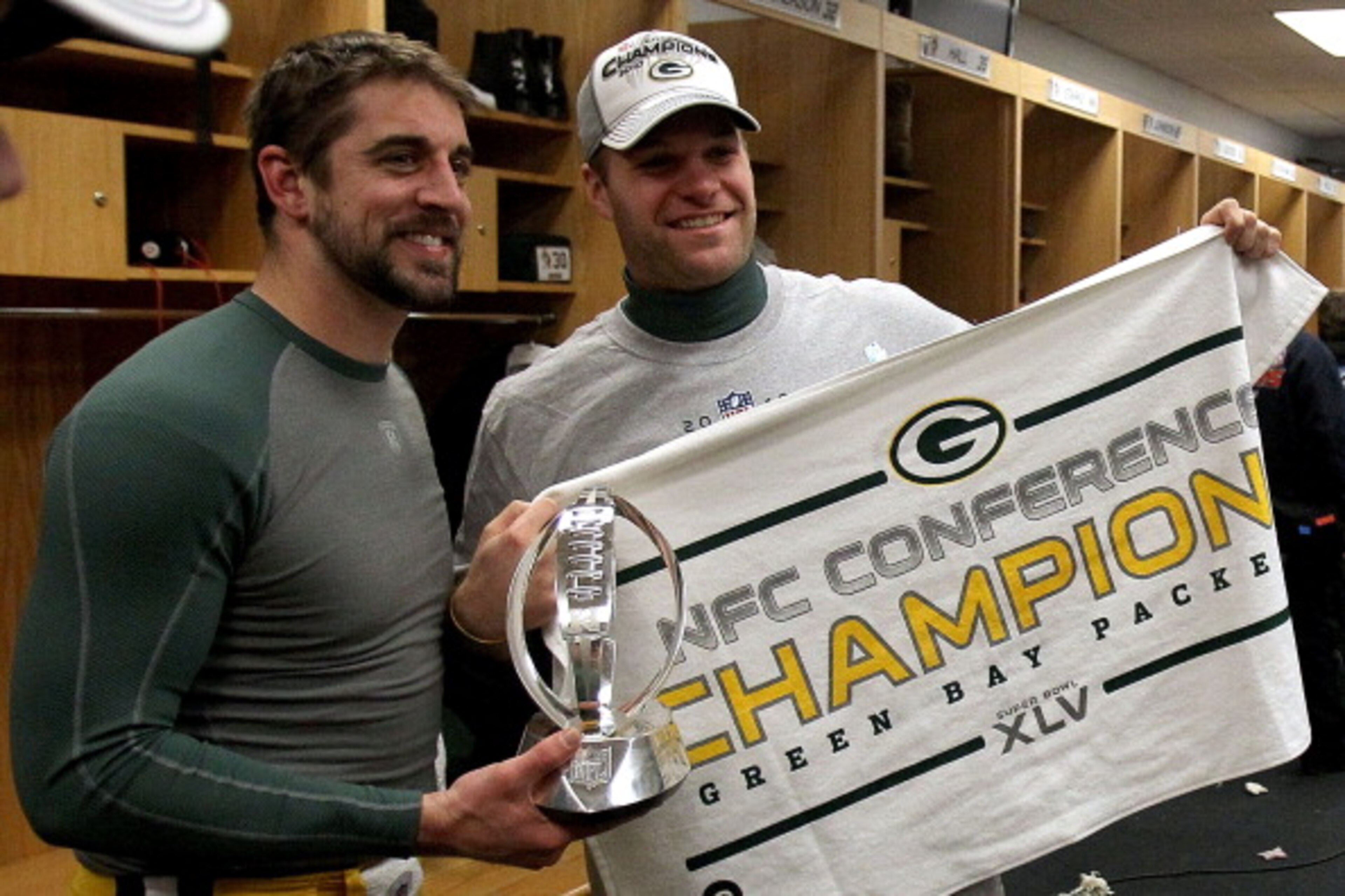 CHICAGO, IL - JANUARY 23:  (L-R) Quarterback Aaron Rodgers #12 and Matt Flynn #10 of the Green Bay Packers celebrate the Packers 21-14 victory against the Chicago Bears with the George Halas Trophy after the NFC Championship Game at Soldier Field on Janua