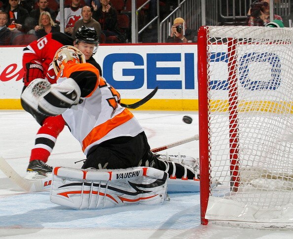 NEWARK, NJ - APRIL 01:  Goalie Brian Boucher #33 of the Philadelphia Flyers misses this shot by Patrik Elias #26 of the New Jersey Devils for his second goal of the night during the second period of an NHL hockey game at the Prudential Center on April 1,