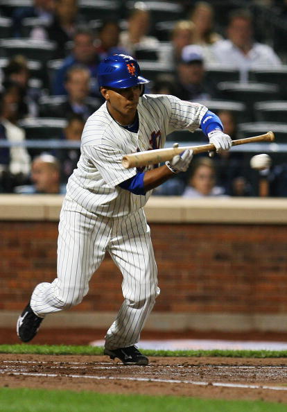 NEW YORK - SEPTEMBER 15:  Ruben Tejada #11 the New York Mets bunts against the Pittsburgh Pirates on September 15, 2010 at Citi Field in the Flushing neighborhood of the Queens borough of New York City.  (Photo by Andrew Burton/Getty Images)