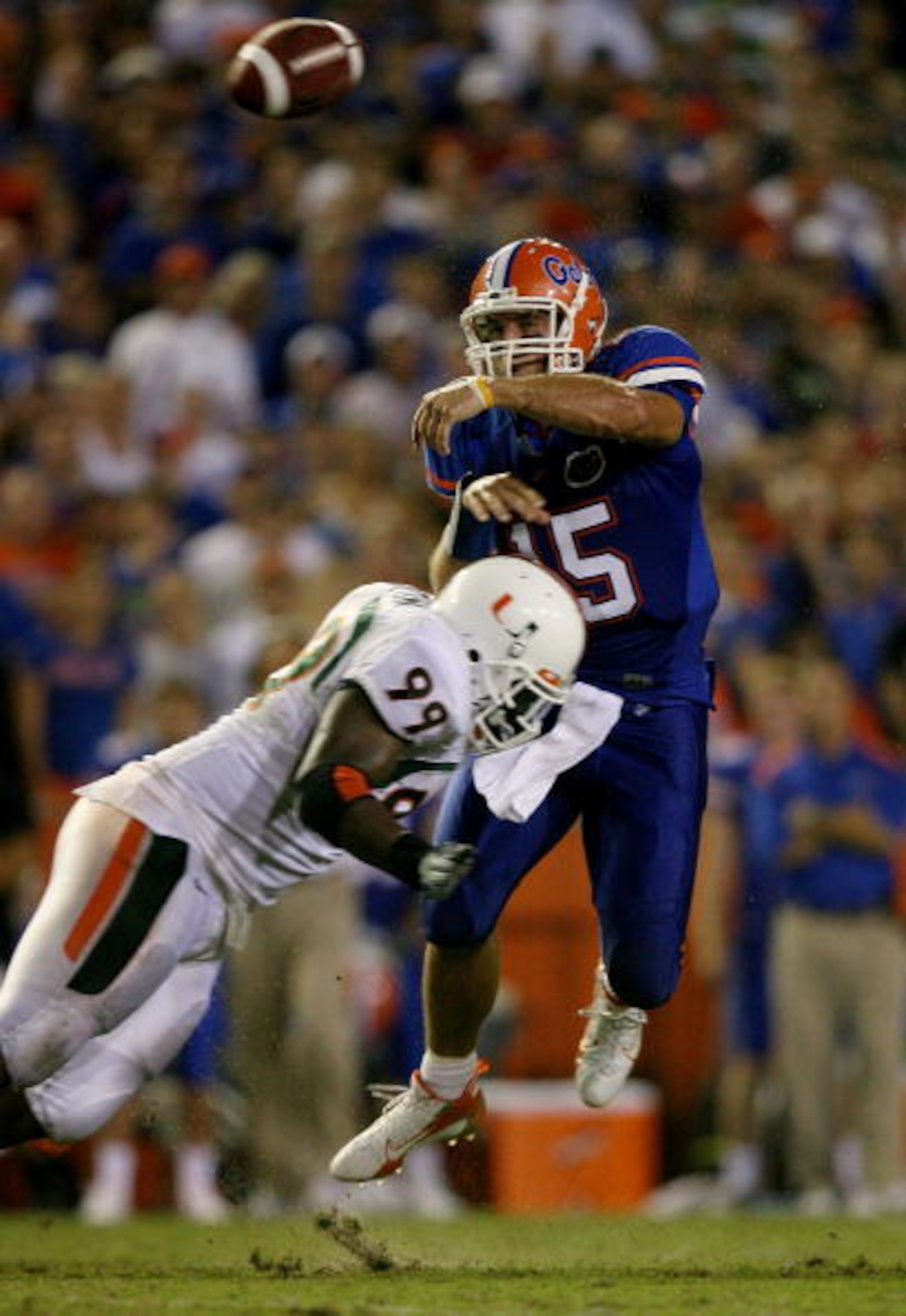 GAINESVILLE, FL - SEPTEMBER 06: Quarterback Tim Tebow #15 of the Florida Gators throws a pass as he is hit by Marcus Forston #99 of the Miami Hurricanes at Ben Hill Griffin Stadium on September 6, 2008 in Gainesville, Florida. (Photo by Doug Benc/Getty GAINESVILLE, FL - SEPTEMBER 06: Quarterback Tim Tebow #15 of the Florida Gators throws a pass as he is hit by Marcus Forston #99 of the Miami Hurricanes at Ben Hill Griffin Stadium on September 6, 2008 in Gainesville, Florida. (Photo by Doug Benc/Getty