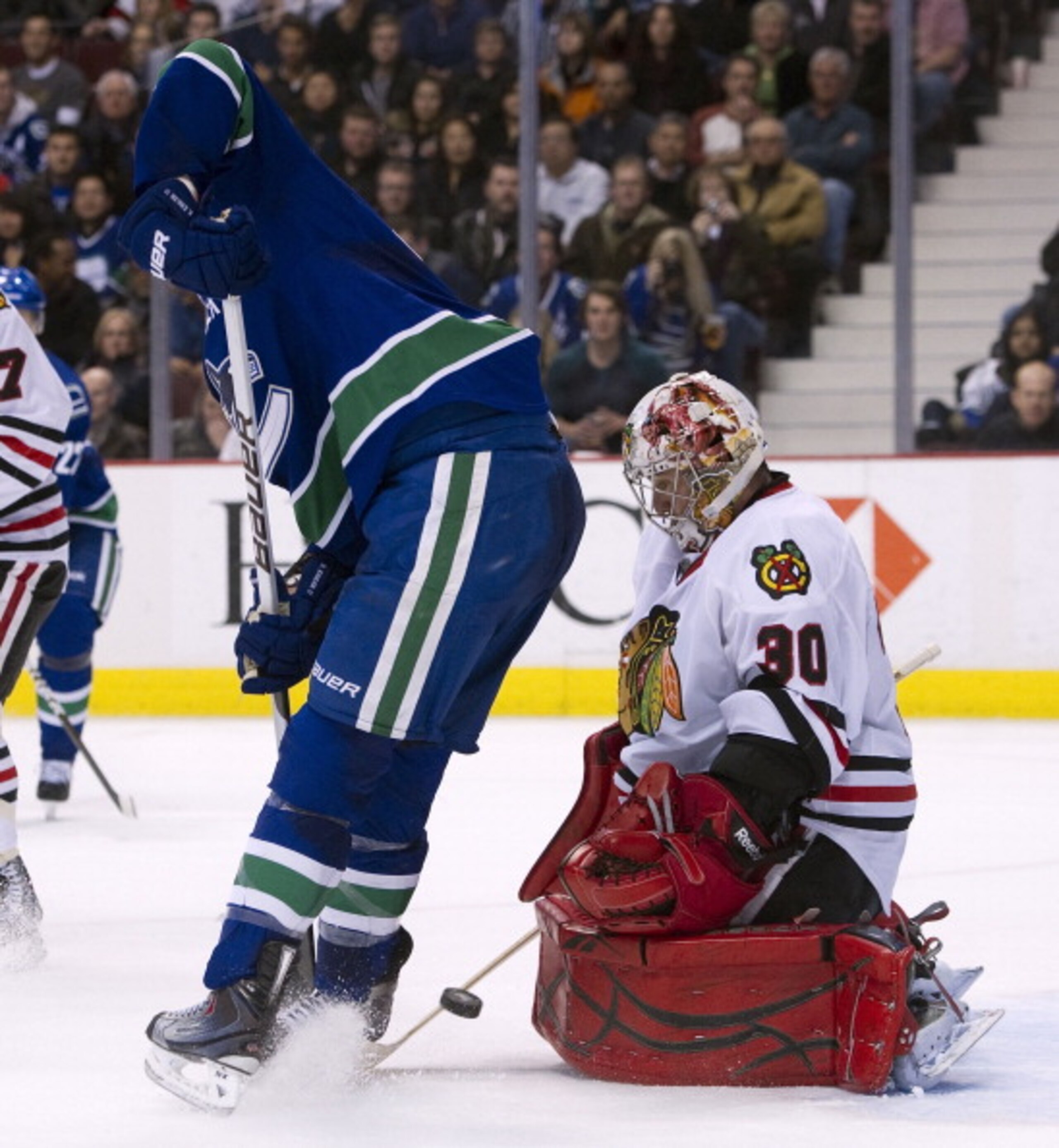 VANCOUVER, CANADA - FEBRUARY 4: Goalie Marty Turco #30 of the Chicago Blackhawks makes a pad save while Ryan Kesler #17 of the Vancouver Canucks tries to screen and redirect the puck during the second period in NHL action on February 04, 2011 at Rogers Ar VANCOUVER, CANADA - FEBRUARY 4: Goalie Marty Turco #30 of the Chicago Blackhawks makes a pad save while Ryan Kesler #17 of the Vancouver Canucks tries to screen and redirect the puck during the second period in NHL action on February 04, 2011 at Rogers Ar