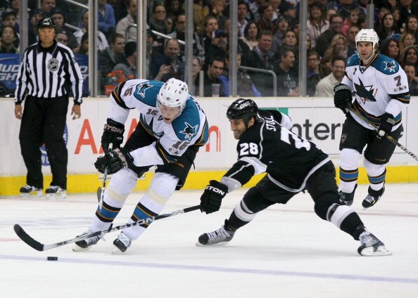 LOS ANGELES, CA - MARCH 24:  Jarret Stoll #28 of the Los Angeles Kings swipes the puck away from the stick of Dany Heatley #15 of the San Jose Sharks during the NHL game at Staples Center on March 24, 2011 in Los Angeles, California. The Kings defeated th