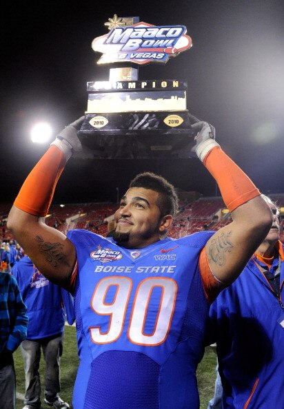 LAS VEGAS, NV - DECEMBER 22:  Billy Winn #90 of the Boise State Broncos holds up a trophy as he celebrates the team's 26-3 victory over the Utah Utes in the MAACO Bowl Las Vegas at Sam Boyd Stadium December 22, 2010 in Las Vegas, Nevada.  (Photo by Ethan