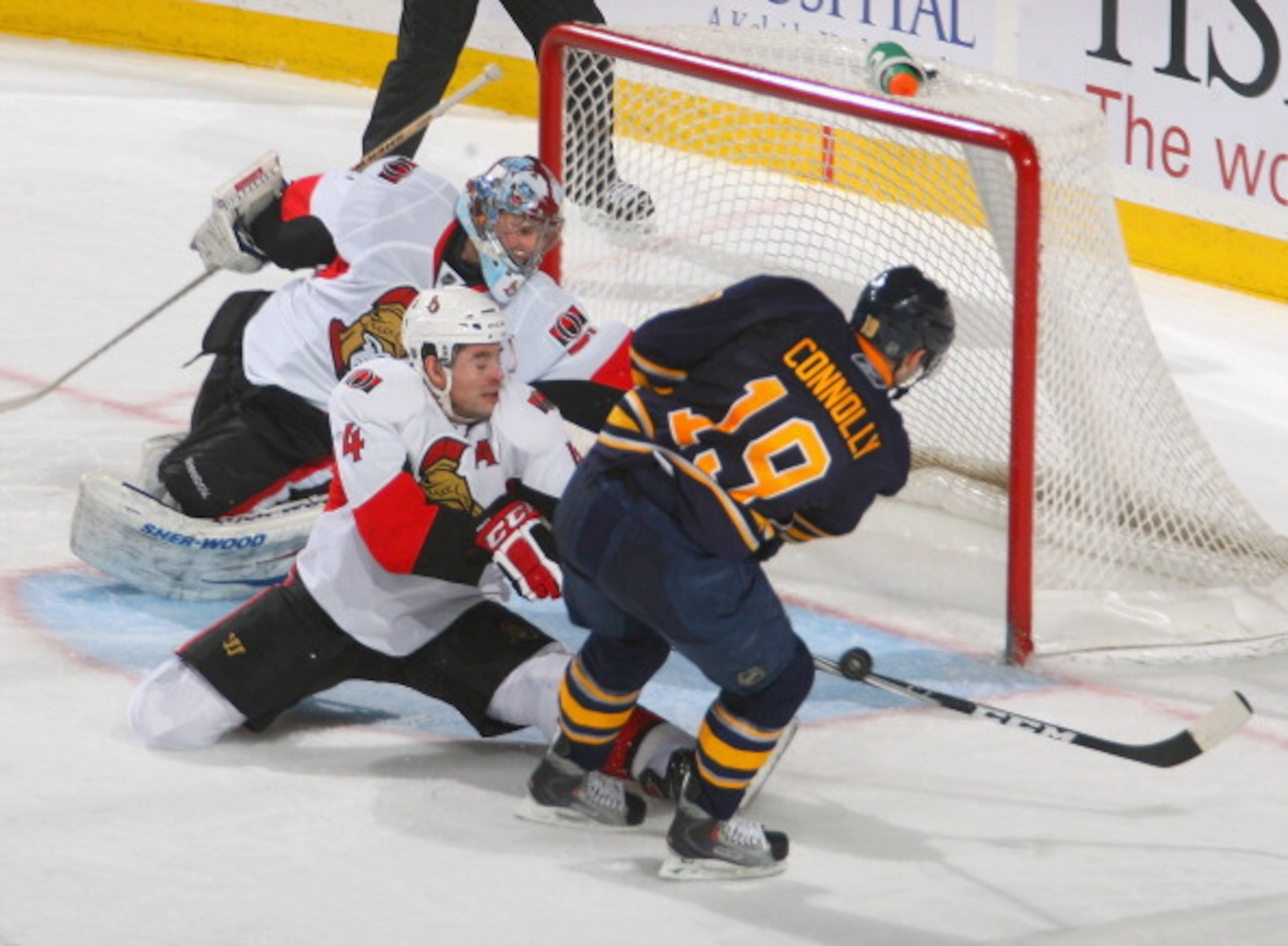 BUFFALO, NY - FEBRUARY 25: Chris Phillips #4 of the Ottawa Senators stops a shot with the shaft of his stick on Tim Connolly #19 of the Buffalo Sabres at HSBC Arena on February 25, 2011 in Buffalo, New York. Buffalo won 4-2.  (Photo by Rick Stewart/Getty
