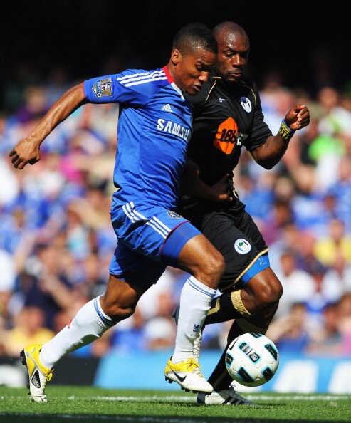 LONDON, ENGLAND - APRIL 09:  Florent Malouda of Chelsea takes on Emmerson Boyce of Wigan Athletic during the Barclays Premier League match between Chelsea and Wigan Athletic at Stamford Bridge on April 9, 2011 in London, England.  (Photo by Clive Rose/Get