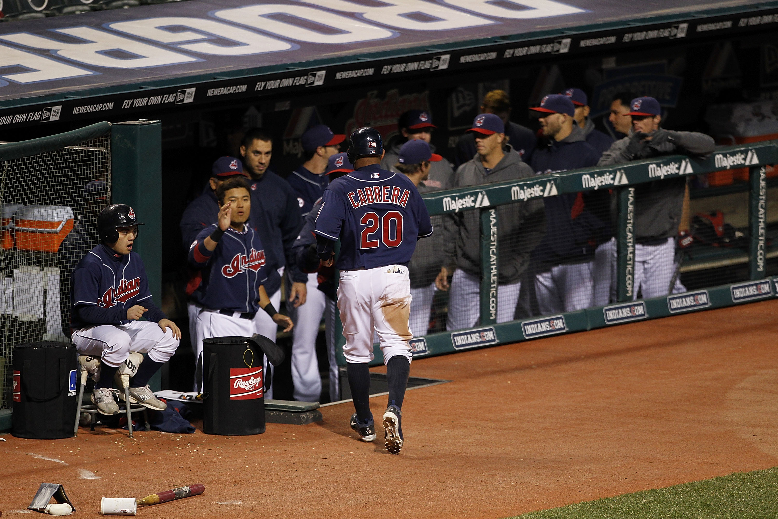CLEVELAND - APRIL 05: Orlando Cabrera #20 of the Cleveland Indians scores in the fourth inning and is congratulated by his teammates during the game against the Boston Red Sox at Progressive Field on April 5, 2011 in Cleveland, Ohio.  (Photo by Leon Halip
