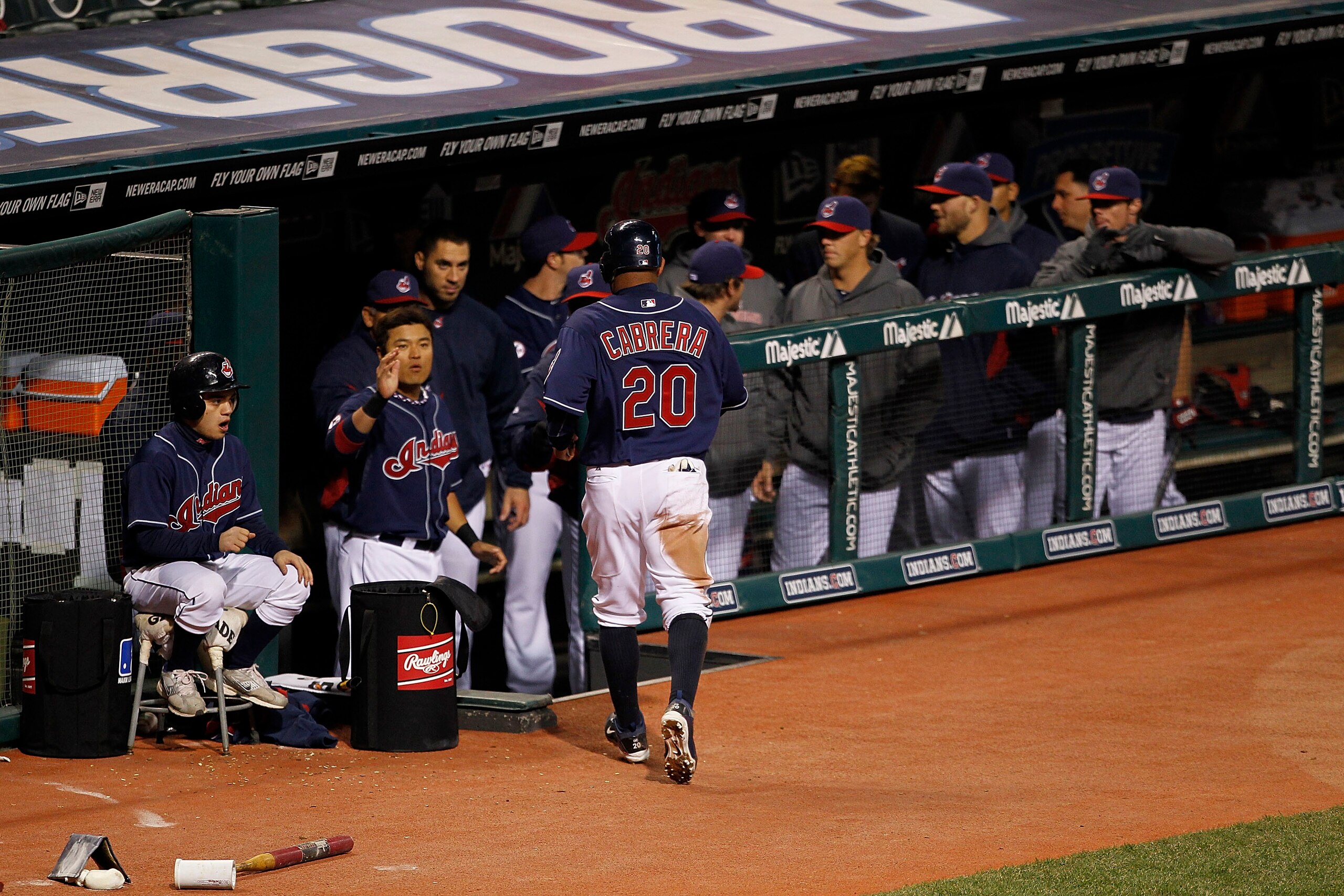 CLEVELAND - APRIL 05: Orlando Cabrera #20 of the Cleveland Indians scores in the fourth inning and is congratulated by his teammates during the game against the Boston Red Sox at Progressive Field on April 5, 2011 in Cleveland, Ohio.  (Photo by Leon Halip