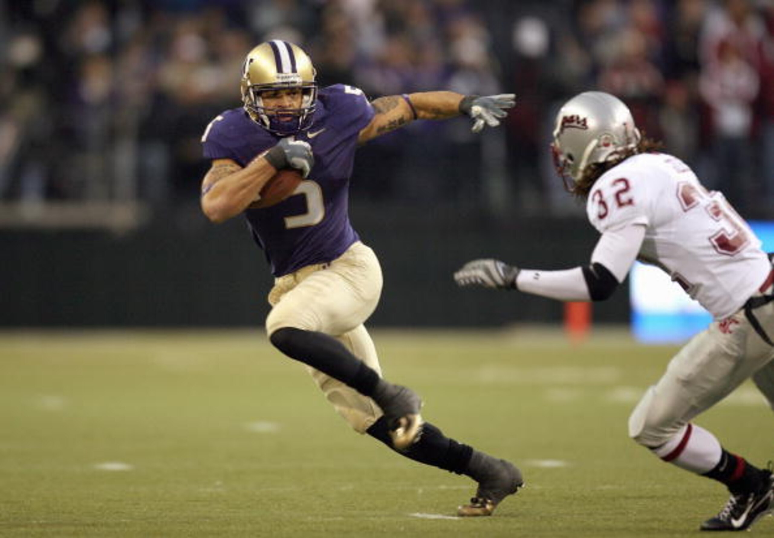 SEATTLE - NOVEMBER 24: Anthony Russo #5 of the Washington Huskies rushes against Reid Forrest #32 of the Washington State Cougars during the 100th Apple Cup game at Husky Stadium on November 24, 2007 in Seattle, Washington. (Photo by Otto Greule Jr/Getty