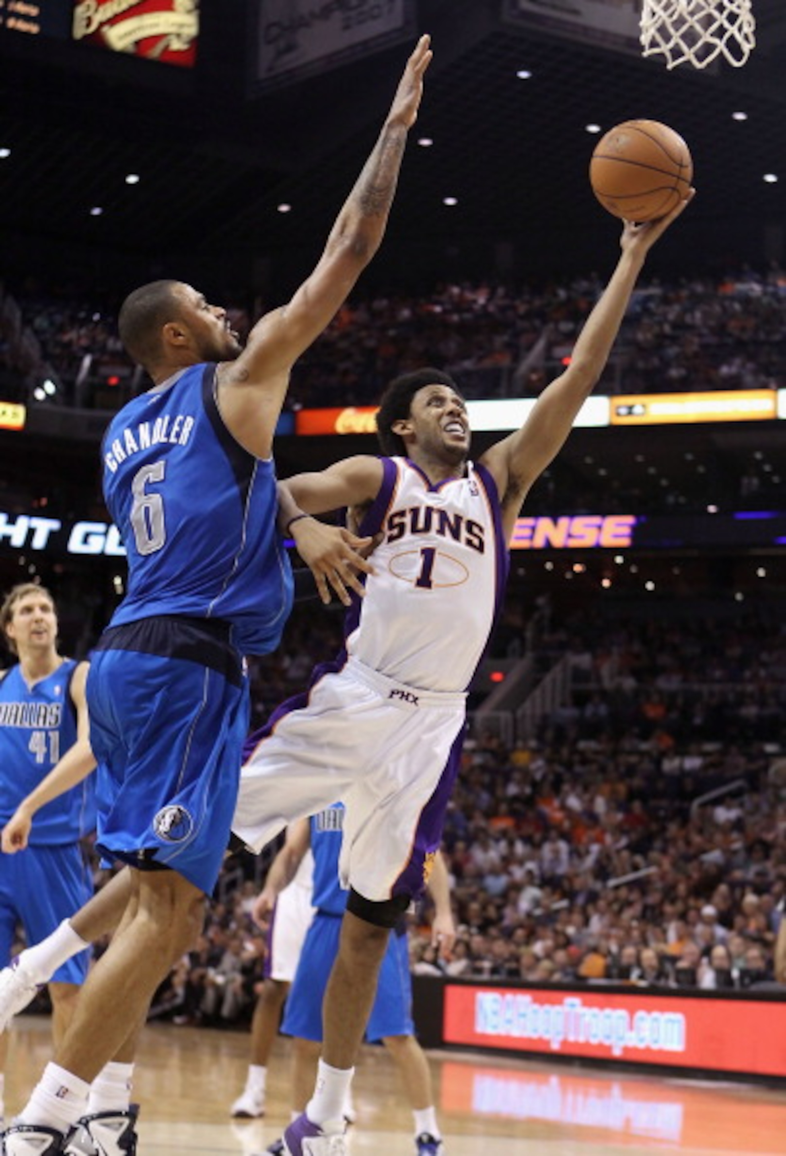 PHOENIX, AZ - MARCH 27:  Josh Childress #1 of the Phoenix Suns lays up a shot against Tyson Chandler #6 of the Dallas Mavericks during the NBA game at US Airways Center on March 27, 2011 in Phoenix, Arizona. The Mavericks defeated the Suns 91-83. NOTE TO