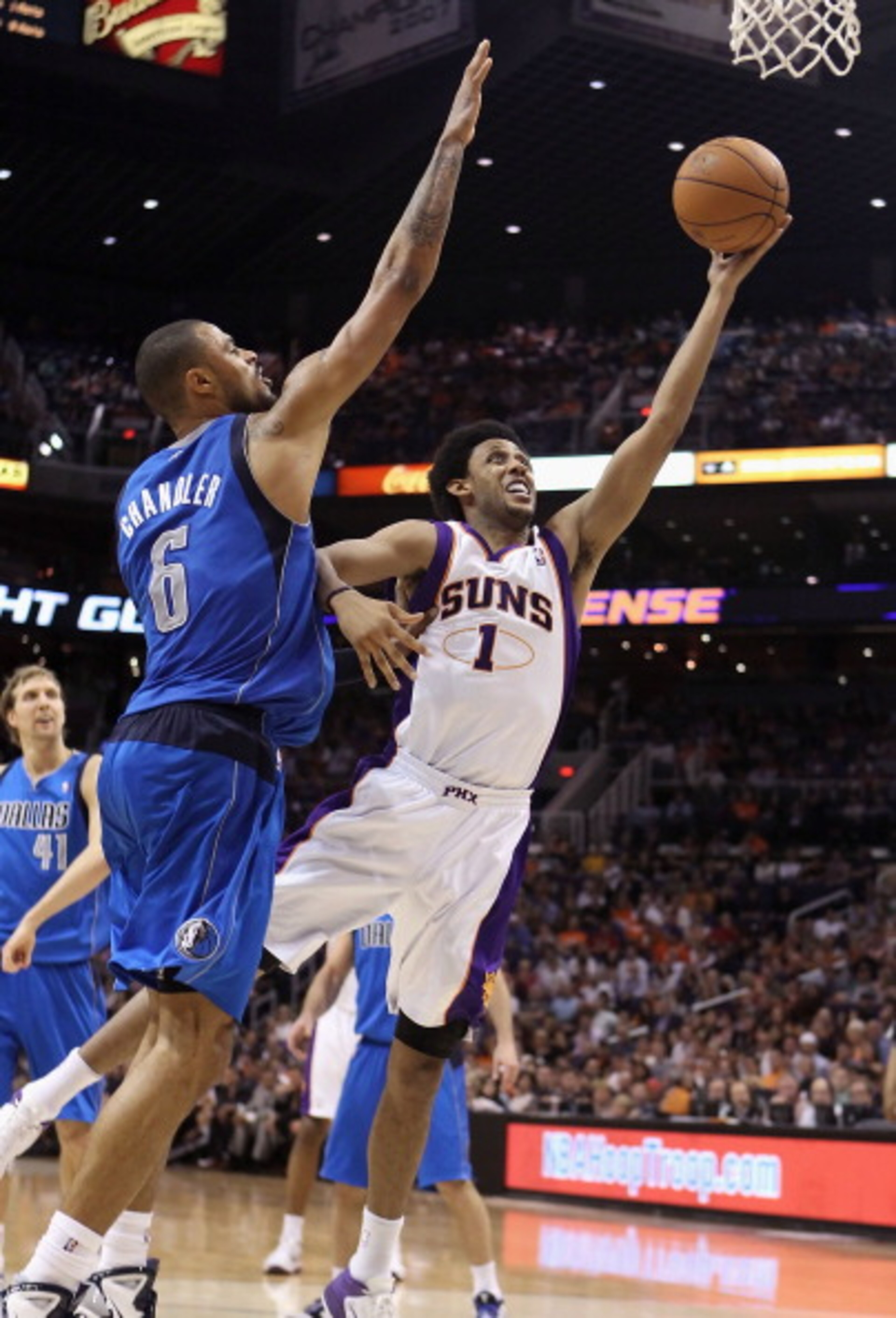 PHOENIX, AZ - MARCH 27:  Josh Childress #1 of the Phoenix Suns lays up a shot against Tyson Chandler #6 of the Dallas Mavericks during the NBA game at US Airways Center on March 27, 2011 in Phoenix, Arizona. The Mavericks defeated the Suns 91-83. NOTE TO