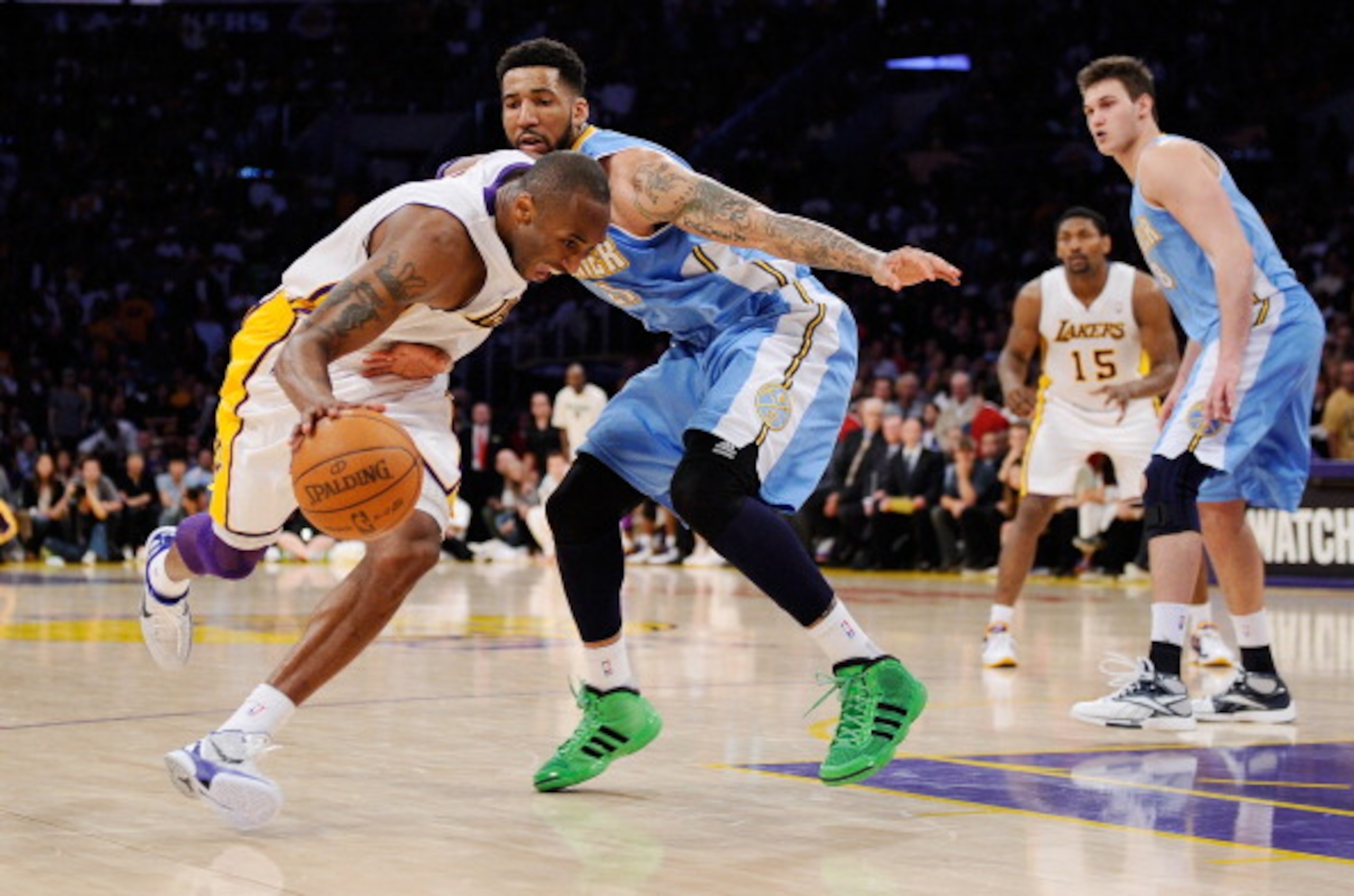 LOS ANGELES, CA - APRIL 03:  Kobe Bryant #24 of the Los Angeles Lakers drives against Wilson Chandler #21 of the Denver Nuggets during the game at Staples Center on April 3, 2011 in Los Angeles, California. NOTE TO USER: User expressly acknowledges and ag