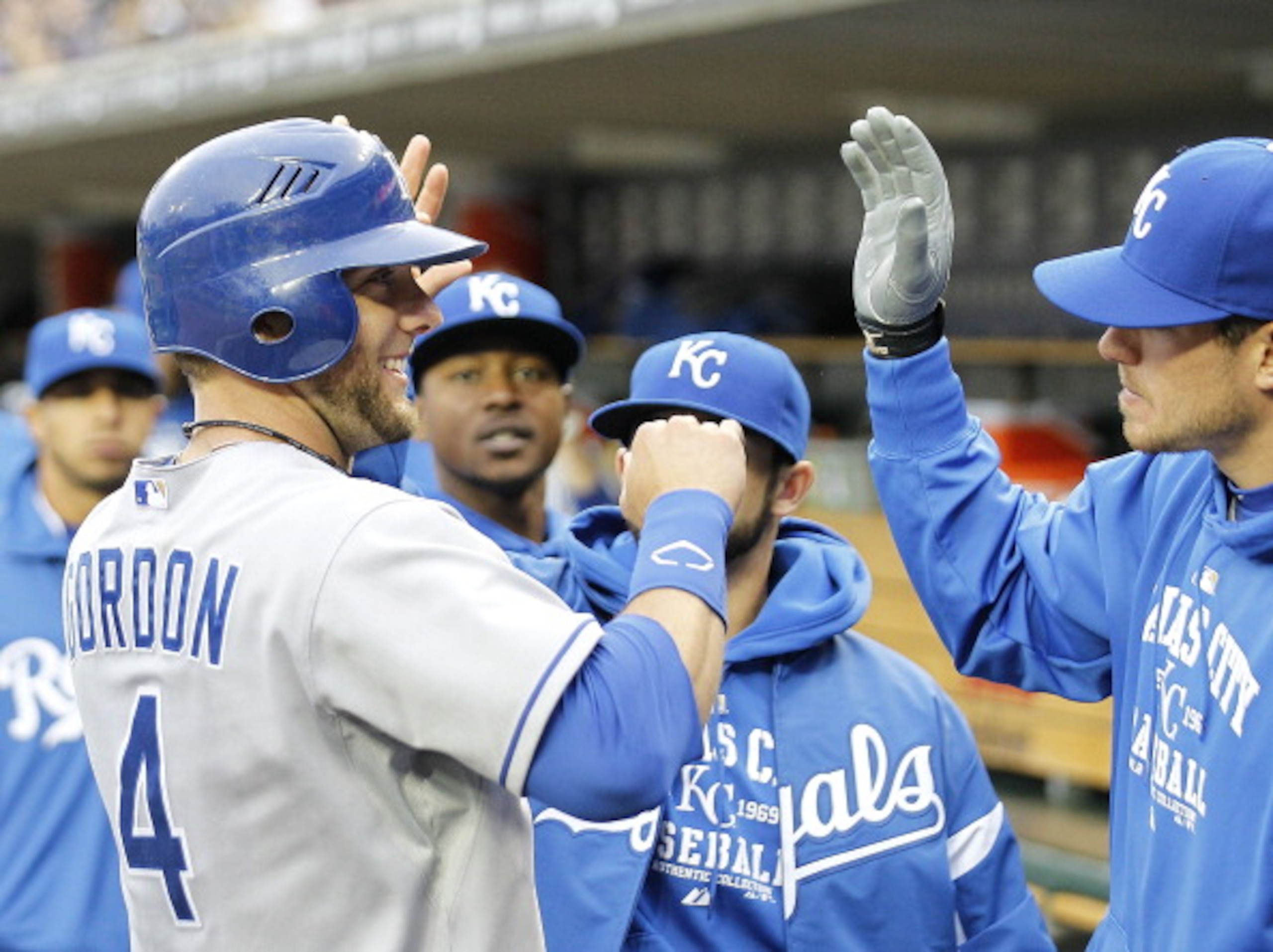 DETROIT - APRIL 09: Alex Gordon #4 of the Kansas City Royals is congratulated by his teammates after scoring in the ninth inning on a sacrifice fly off the bat of Jeff Francoeur (not in photo) during the game against the Detroit Tigers at Comerica Park on DETROIT - APRIL 09: Alex Gordon #4 of the Kansas City Royals is congratulated by his teammates after scoring in the ninth inning on a sacrifice fly off the bat of Jeff Francoeur (not in photo) during the game against the Detroit Tigers at Comerica Park on