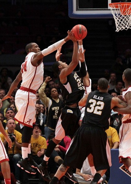 NEW YORK, NY - MARCH 31:  Toure' Murry #23 of the Wichita State Shockers is stopped by Chris Hines #44 of the Alabama Crimson Tide during the 2011 NIT Championship game on March 31, 2011 at Madison Square Garden in New York City. Wichita State defeated Al