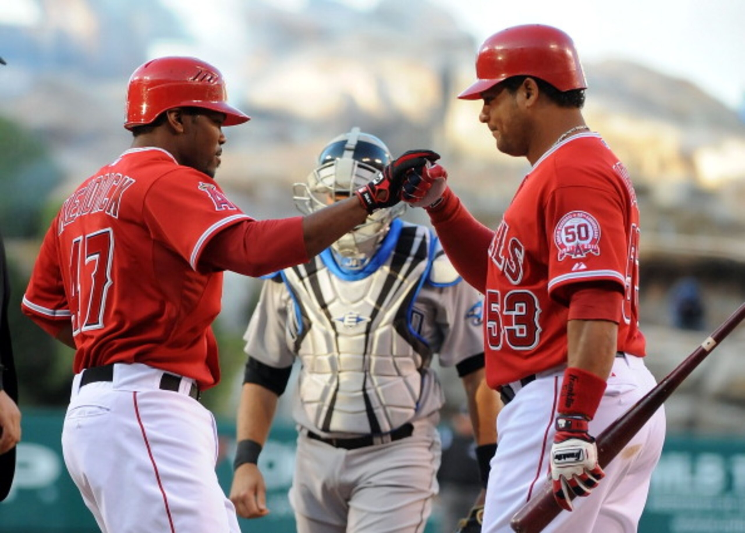 ANAHEIM, CA - APRIL 09: (L-R)Howie Kendrick #47 celebrates with teammate Bobby Abreu #53 of the Los Angeles Angels of Anaheim after scoring in the first inning against the Toronto Blue Jays at Angel Stadium of Anaheim on April 9, 2011 in Anaheim, Califor ANAHEIM, CA - APRIL 09: (L-R)Howie Kendrick #47 celebrates with teammate Bobby Abreu #53 of the Los Angeles Angels of Anaheim after scoring in the first inning against the Toronto Blue Jays at Angel Stadium of Anaheim on April 9, 2011 in Anaheim, Califor