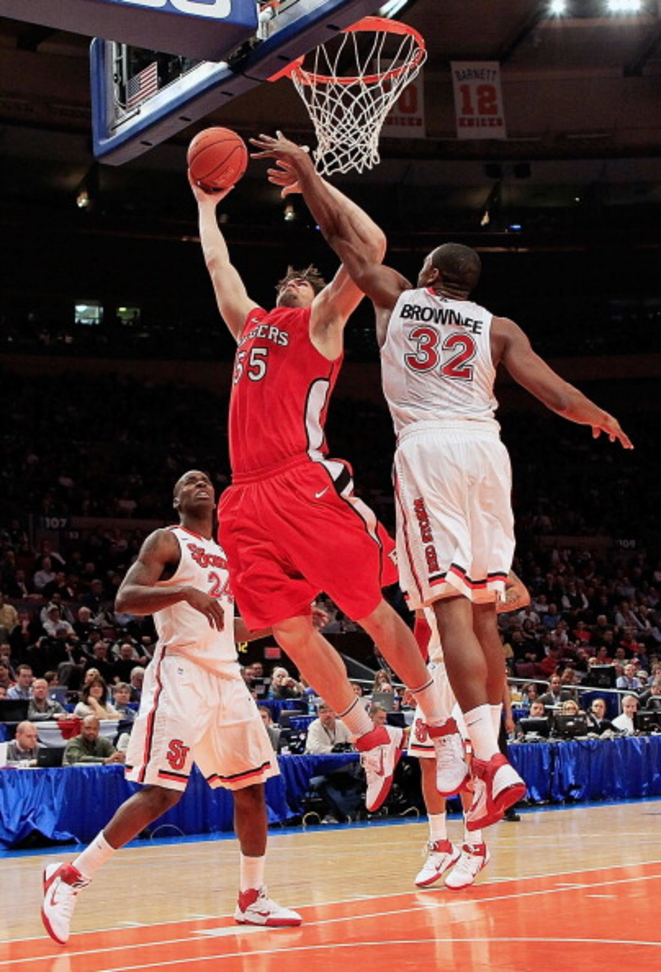 NEW YORK, NY - MARCH 09: Gilvydas Biruta #55 of the Rutgers Scarlet Knights shoots over Justin Brownlee #32 of the St.Johns Red Storm during the second round of the 2011 Big East Men's Basketball Tournament presented by American Eagle Outfitters at Madiso