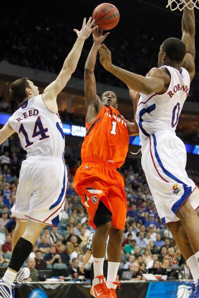 TULSA, OK - MARCH 20:  D.J. Richardson #1 of the Illinois Fighting Illini goes up for a shot against Tyrel Reed #14 and Thomas Robinson #0 of the Kansas Jayhawks during the third round of the 2011 NCAA men's basketball tournament at BOK Center on March 20