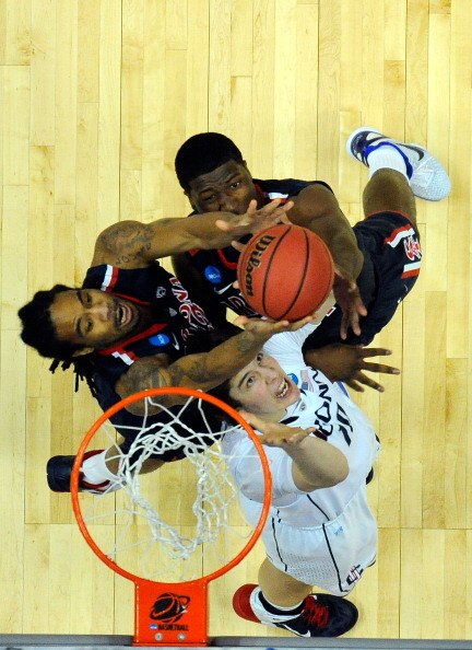 ANAHEIM, CA - MARCH 26:  Jesse Perry #33 and Solomon Hill #44 of the Arizona Wildcats fight for a rebound against Tyler Olander #10 of the Connecticut Huskies during the west regional final of the 2011 NCAA men's basketball tournament at the Honda Center 
