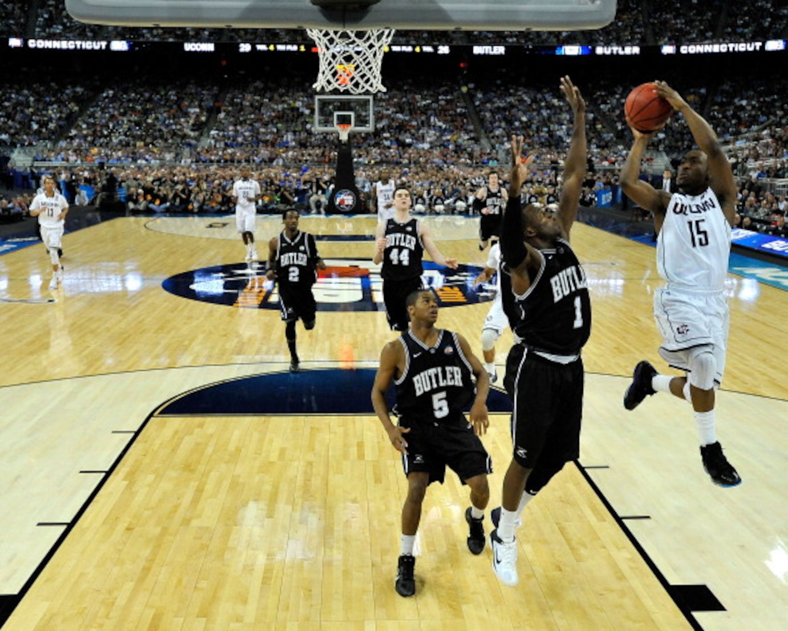 HOUSTON, TX - APRIL 04:  Kemba Walker #15 of the Connecticut Huskies goes to the basket against Shelvin Mack #1 of the Butler Bulldogs during the National Championship Game of the 2011 NCAA Division I Men's Basketball Tournament at Reliant Stadium on Apri
