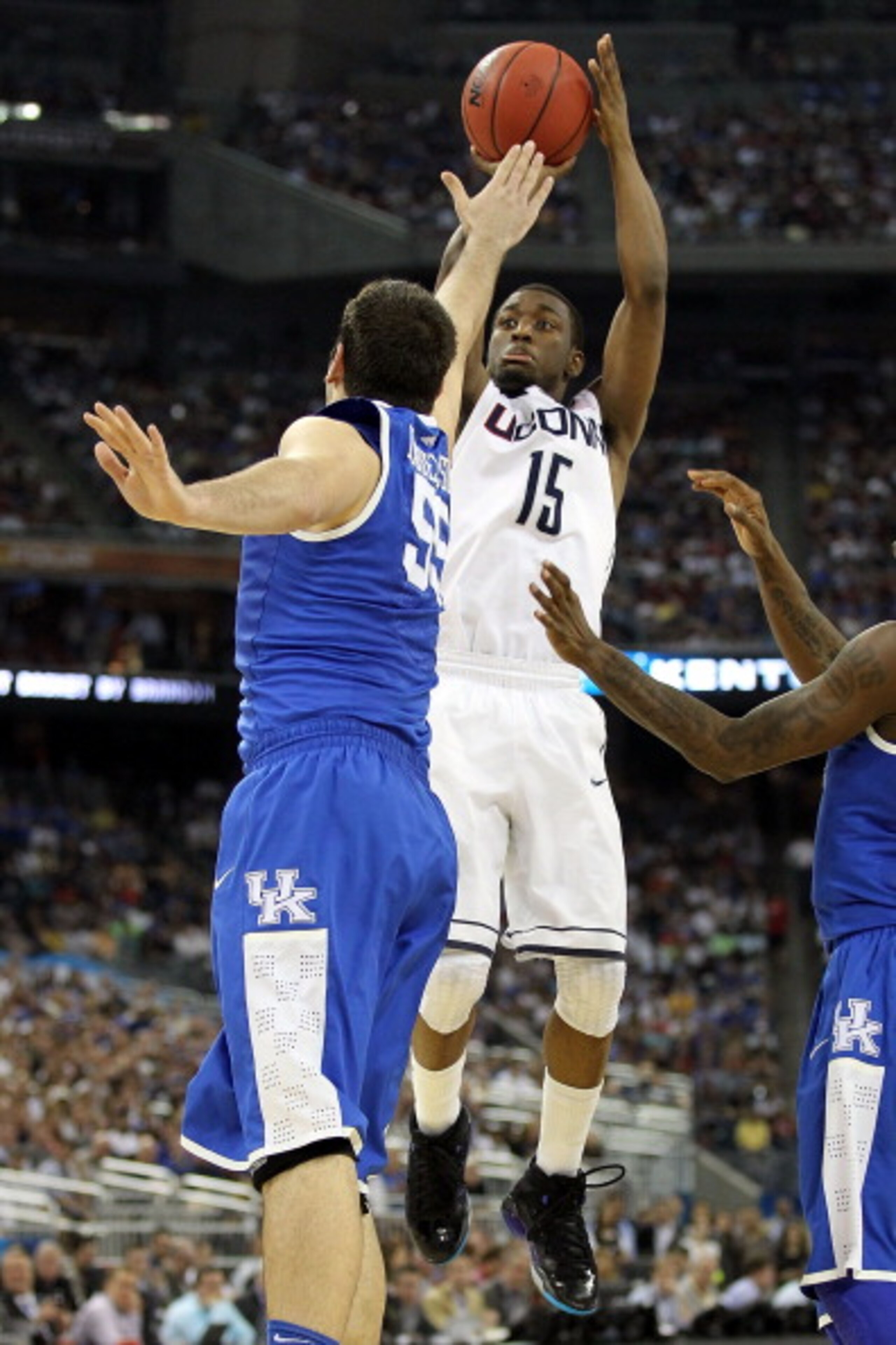 HOUSTON, TX - APRIL 02:  Kemba Walker #15 of the Connecticut Huskies shoots over Josh Harrellson #55 of the Kentucky Wildcats during the National Semifinal game of the 2011 NCAA Division I Men's Basketball Championship at Reliant Stadium on April 2, 2011