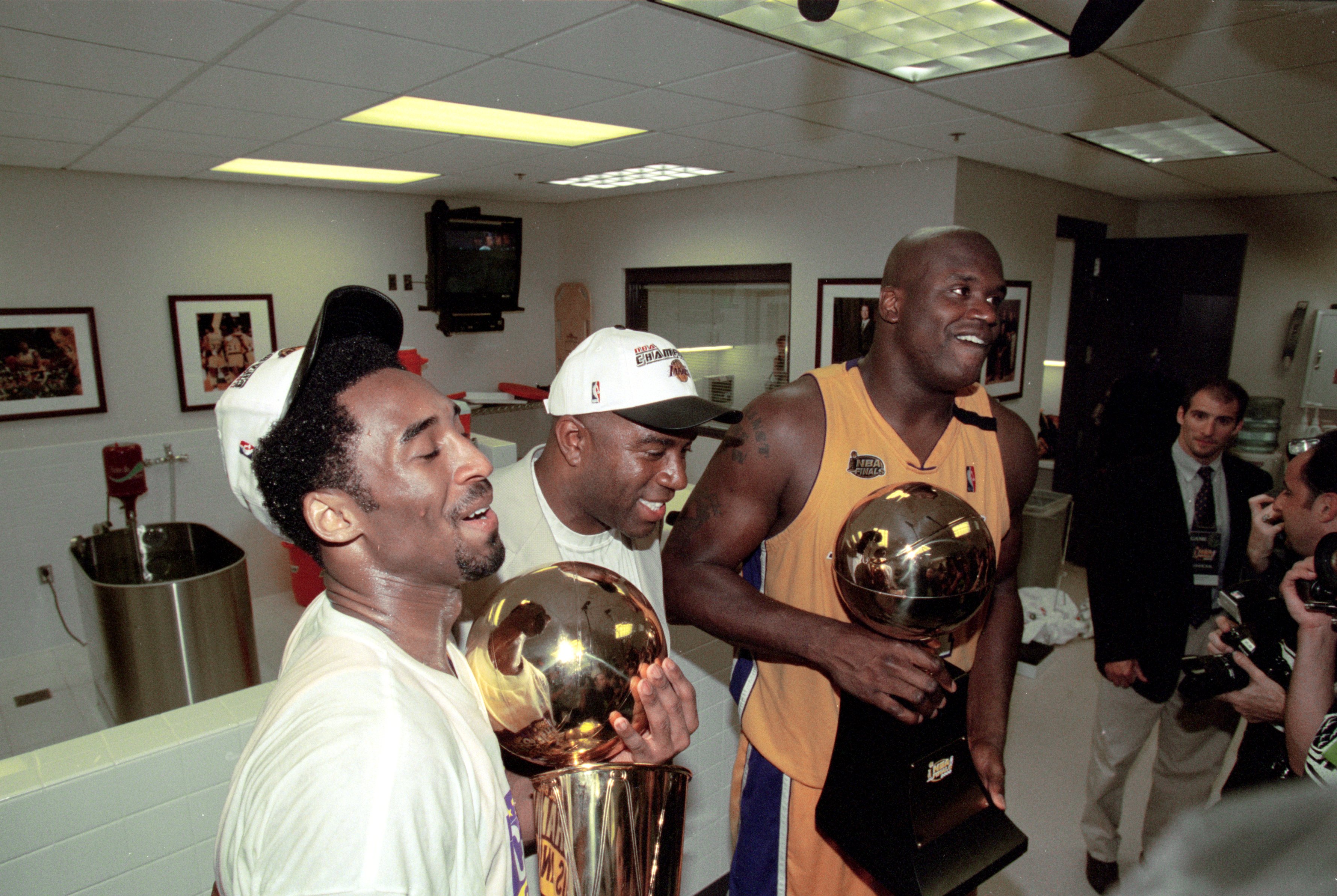 19 Jun 2000:  Kobe Bryant #8 and Shaquille O''Neal #34 of the Los Angeles Lakers hold the NBA Championship trophies with Magic Johnson after winning the NBA Finals Game 6 against the Indiana Pacers at the Staples Center in Los Angeles, California.  The La