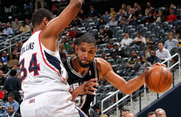 ATLANTA, GA - APRIL 05:  Tim Duncan #21 of the San Antonio Spurs against Jason Collins #34 of the Atlanta Hawks at Philips Arena on April 5, 2011 in Atlanta, Georgia.  NOTE TO USER: User expressly acknowledges and agrees that, by downloading and/or using