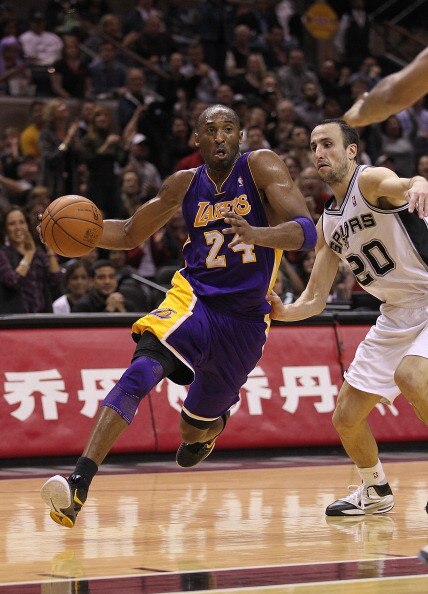 SAN ANTONIO, TX - DECEMBER 28:  Guard Kobe Bryant #24 of the Los Angeles Lakers dribbles the ball against Manu Ginobili #20 of the San Antonio Spurs at AT&T Center on December 28, 2010 in San Antonio, Texas.  NOTE TO USER: User expressly acknowledges and